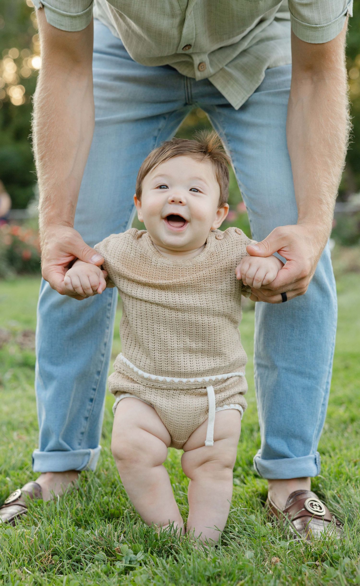 toddler taking first steps during family session in Lyndale Park in Minneapolis, MN