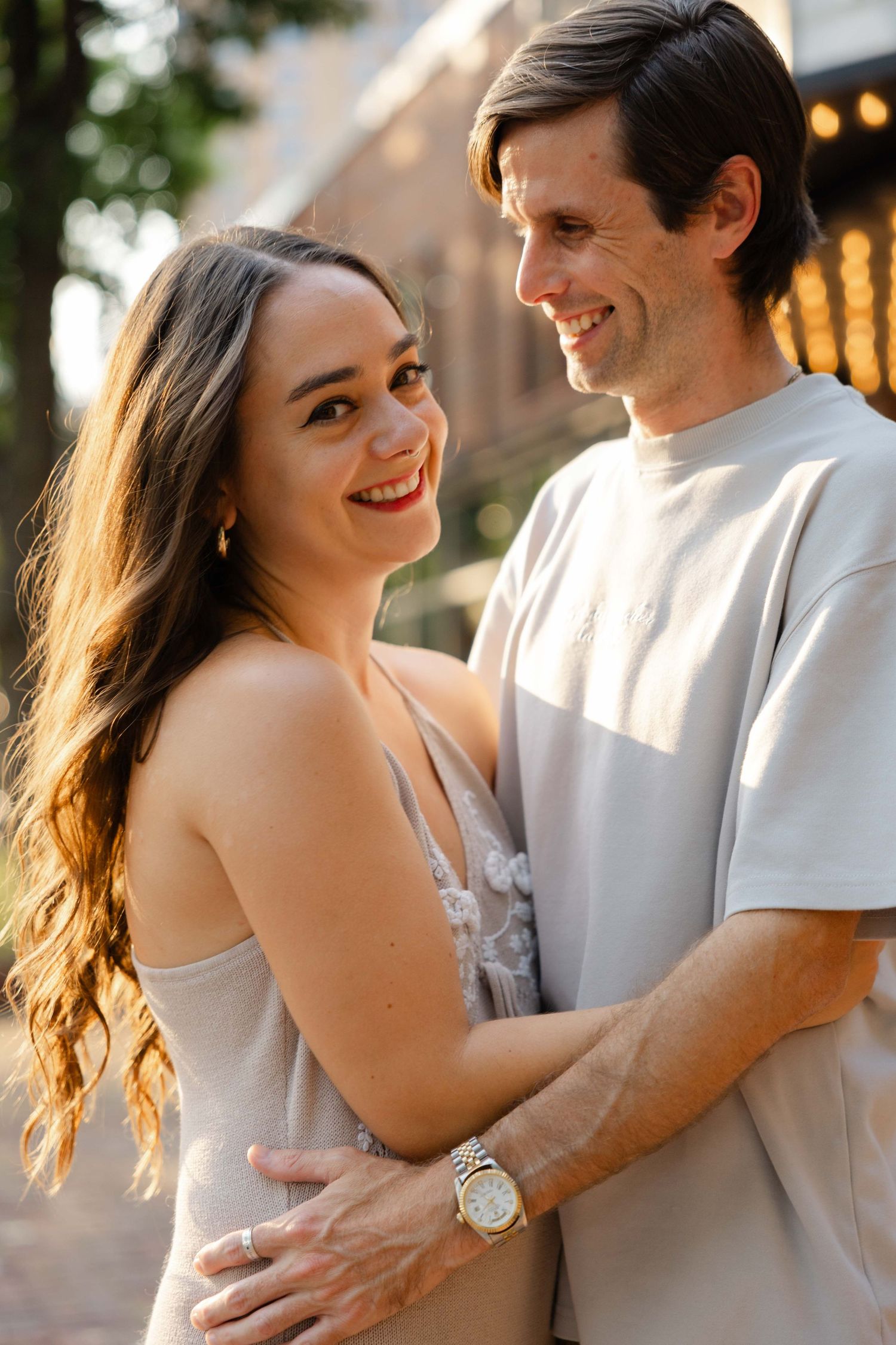 couples session in Minneapolis, saint anthony main street, main cinema in Minneapolis, couple is smilng