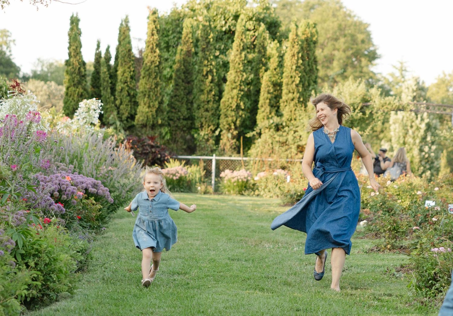 toddler running with her grandma during family session in Apple Valley, candid moments