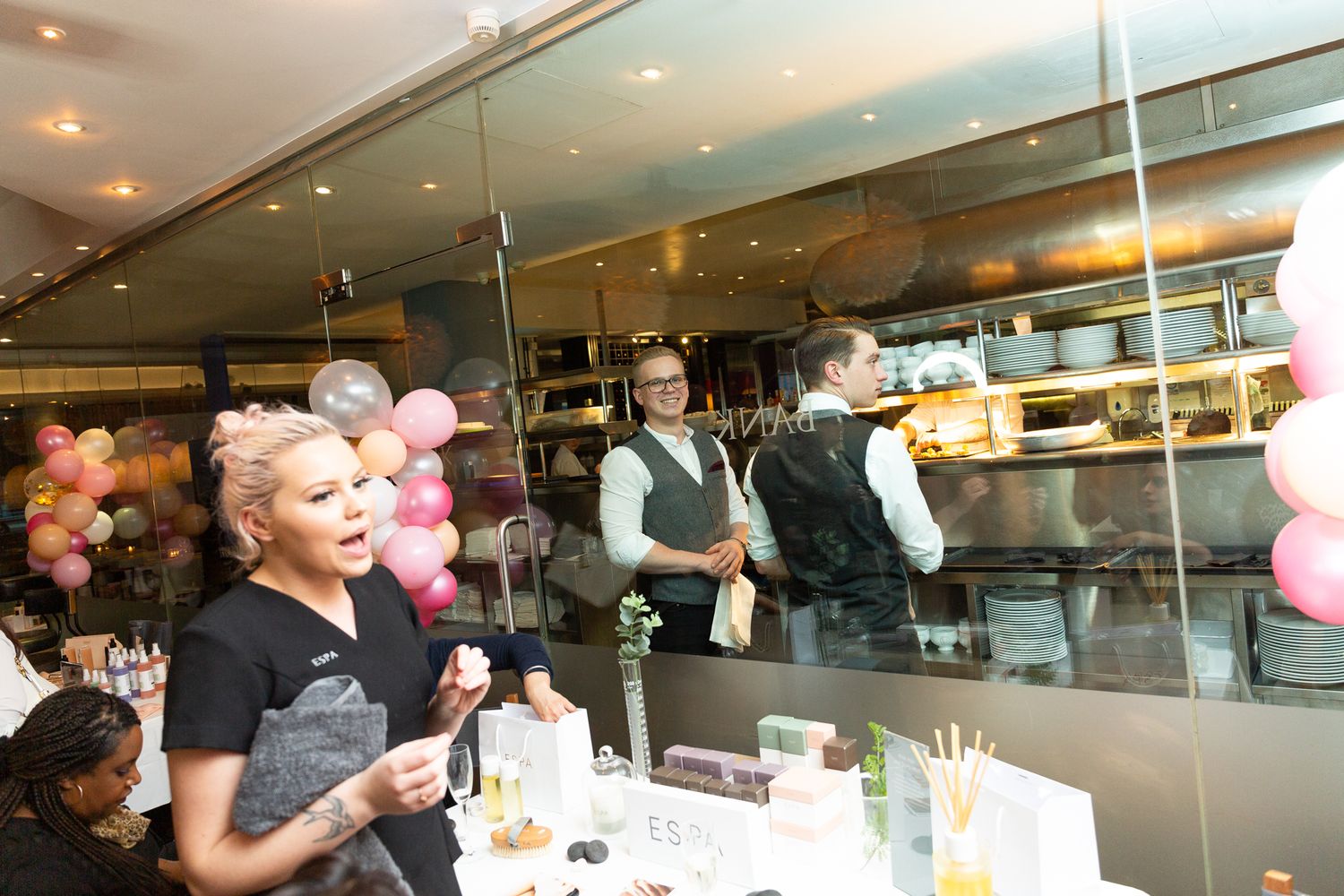 a busy high end restaurant with staff moving about quickly