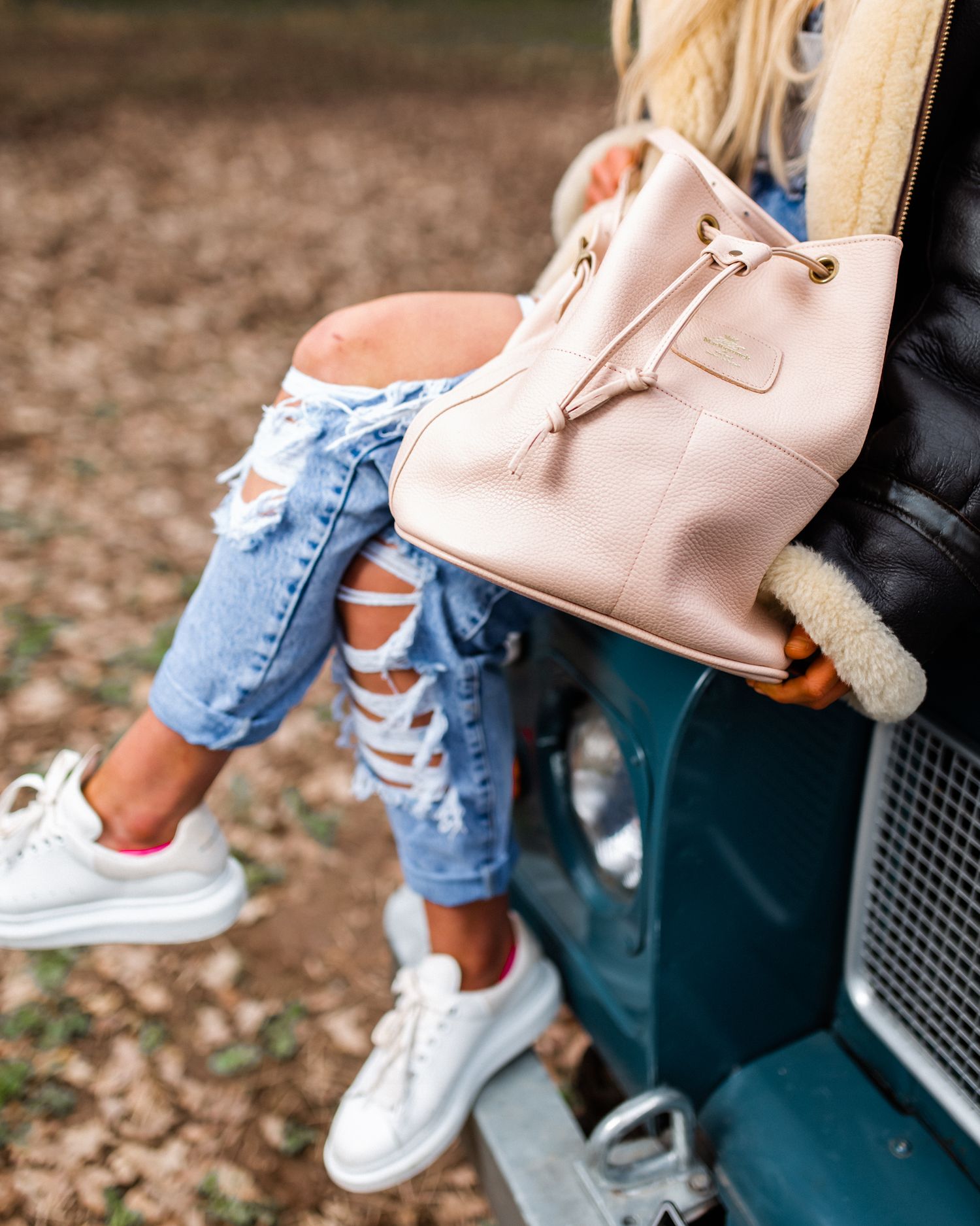 luxury leather handbag with female model on a range rover mark 1