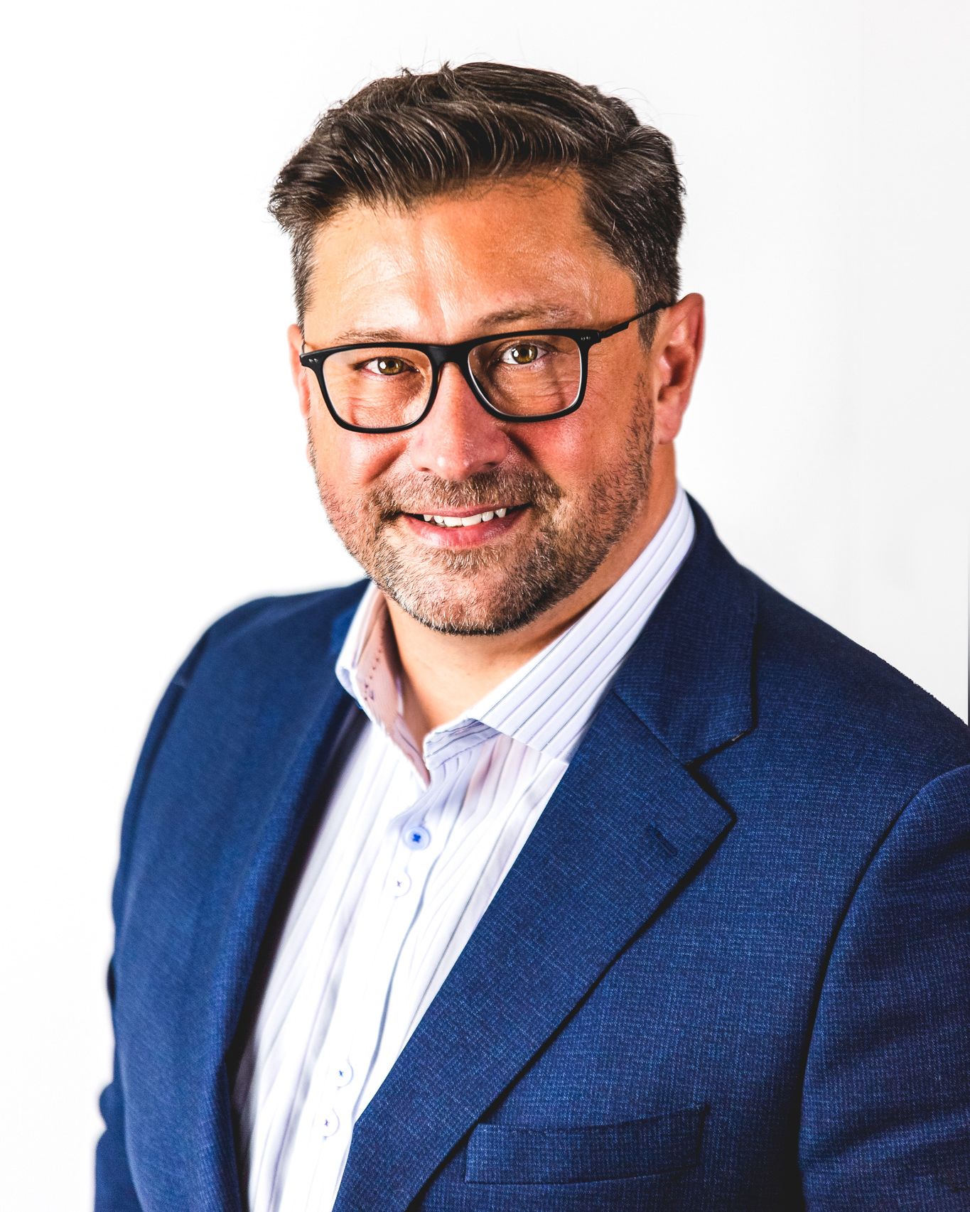 Professional in a navy blue blazer and glasses photographed in multiple angles against white background.