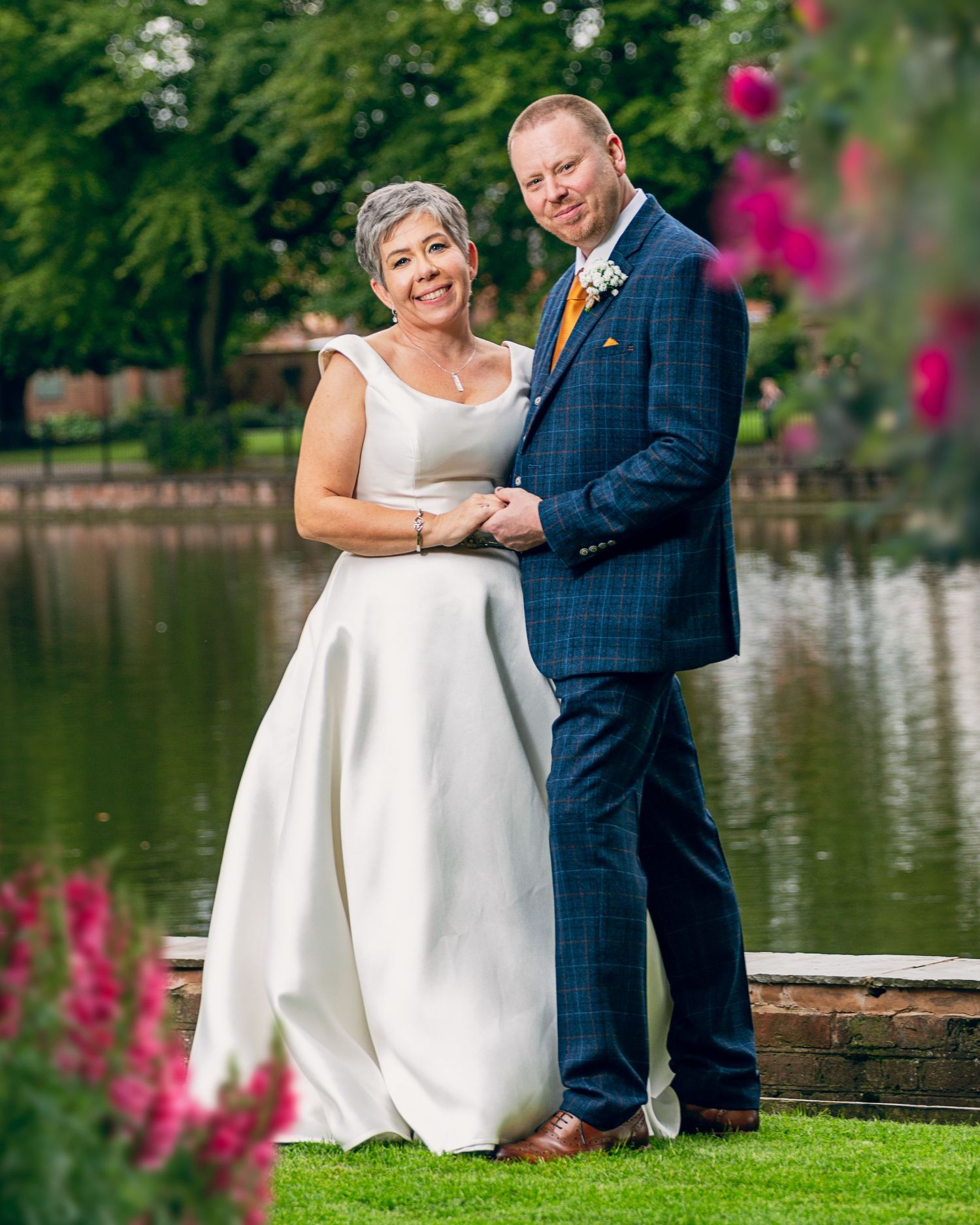 Bride and groom standing next to lake in Lichfield. Picture taken by Matthew Smart Photography, Wolverhampton Best Weddi