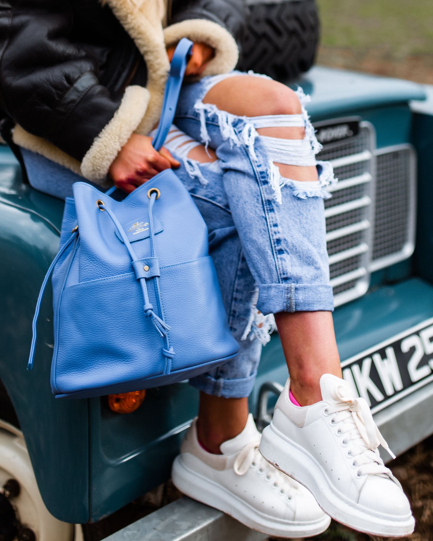 luxury leather handbag with female model on a range rover mark 1