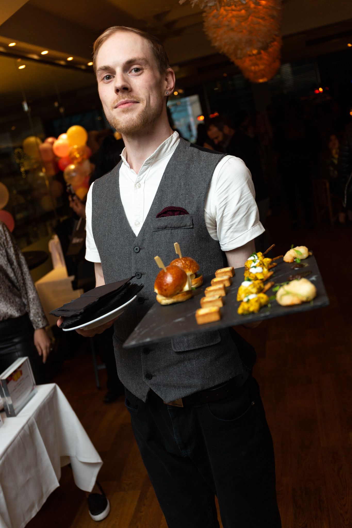 waiter carrying food amuse bouch on tray