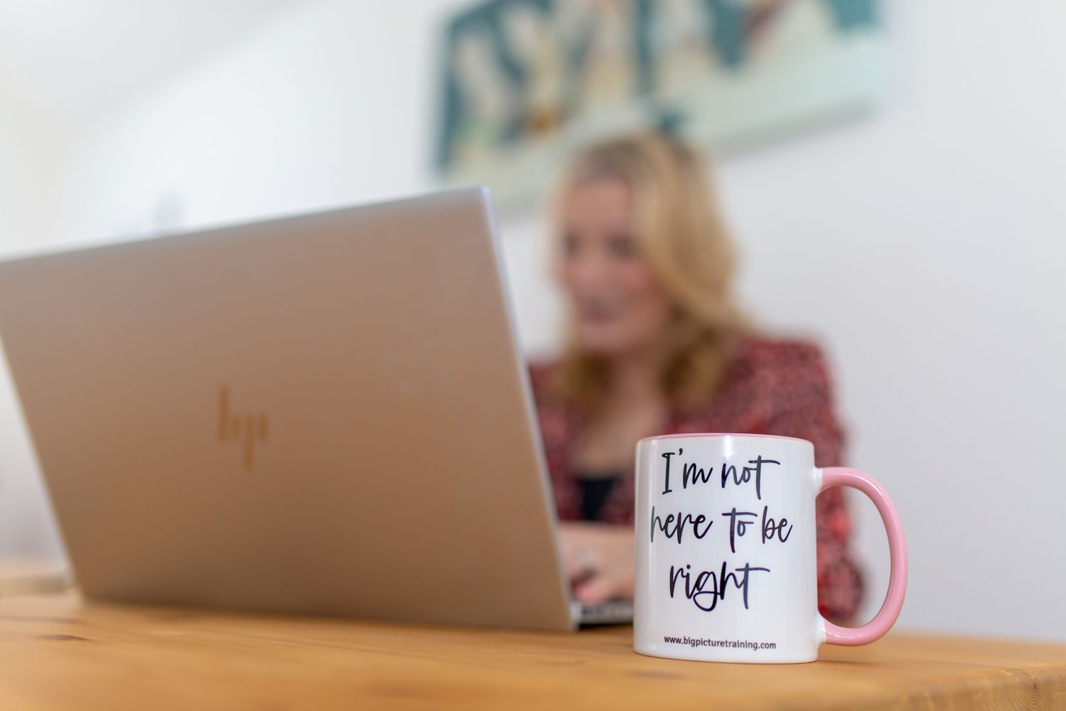 female professional at work looking at camera smiling at work with a passive aggressive mug