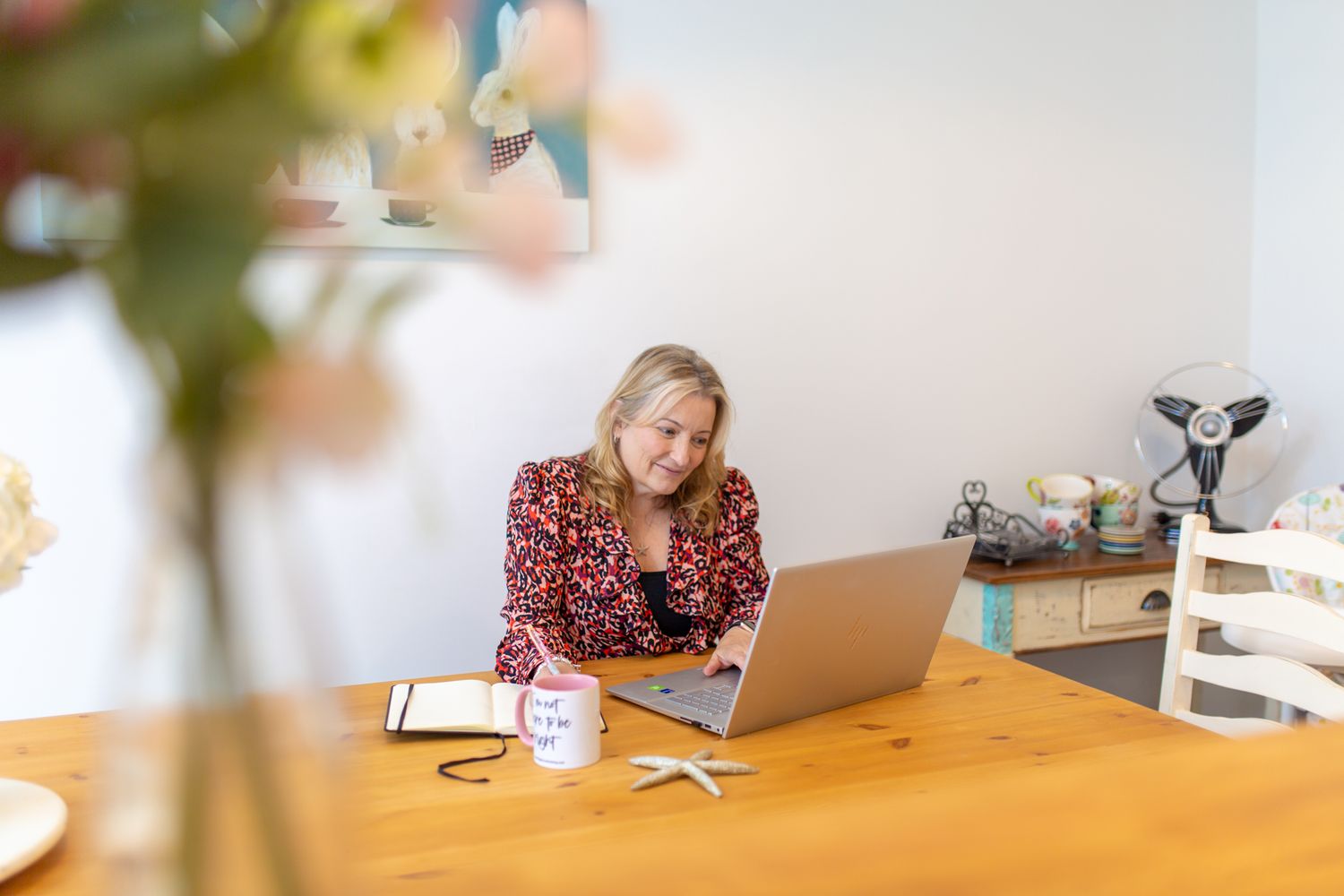 female professional at work typing emails sitting at computer