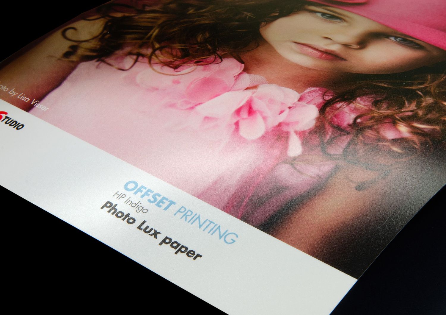 Close-up view of a blurry photo print with pink tones and text overlay showing Offset Printing details.