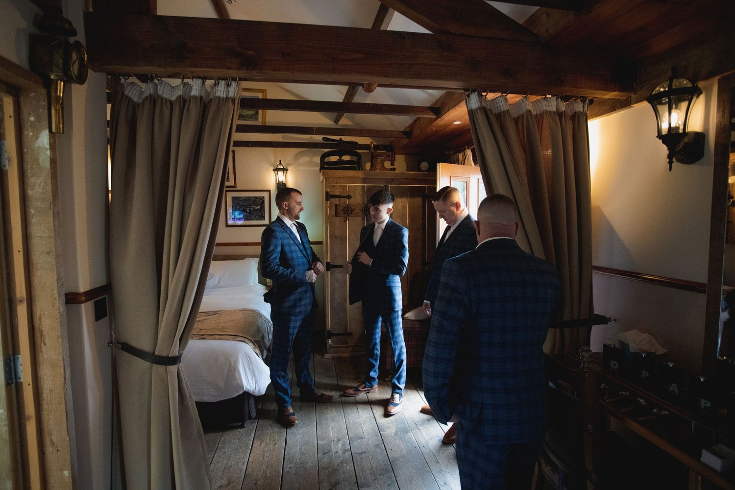 Atmospheric view down a historic wooden corridor illuminated by natural window light.