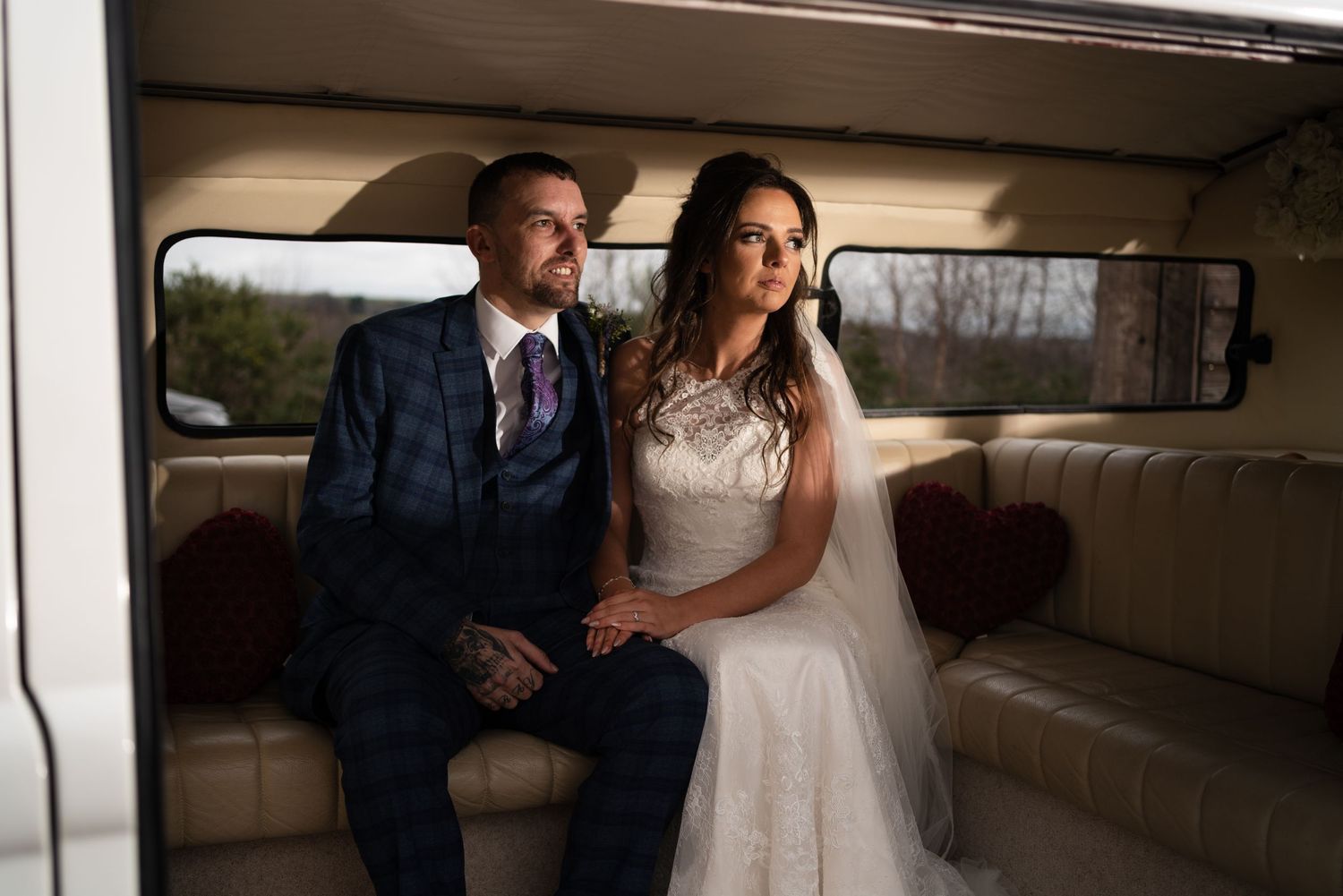 Two people share an intimate moment in a golden-lit interior with tall windows.