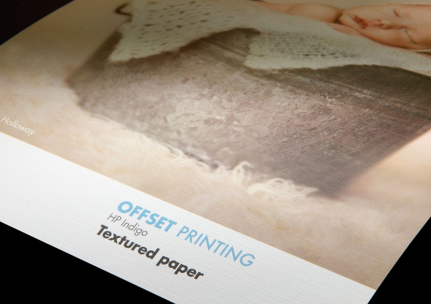 A close-up view of textured paper for offset printing with text label showing details.