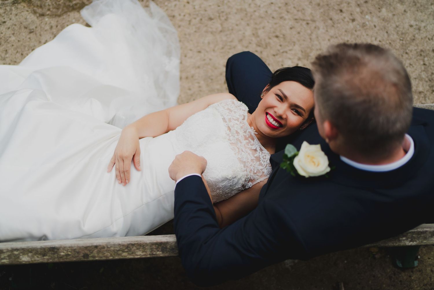 Collage of romantic wedding photos showing couples lying down together in formal attire.