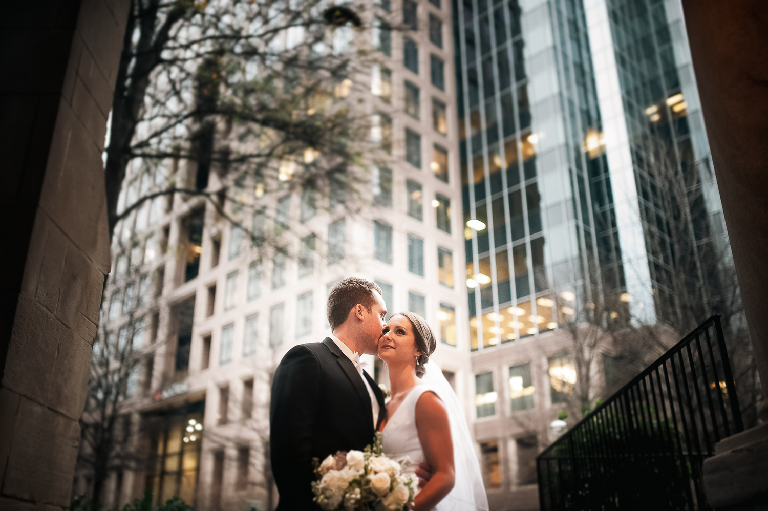 Bride and groom formal portraits during winter wedding in front of skyscrapers at Wimbish House in Atlanta, GA.
