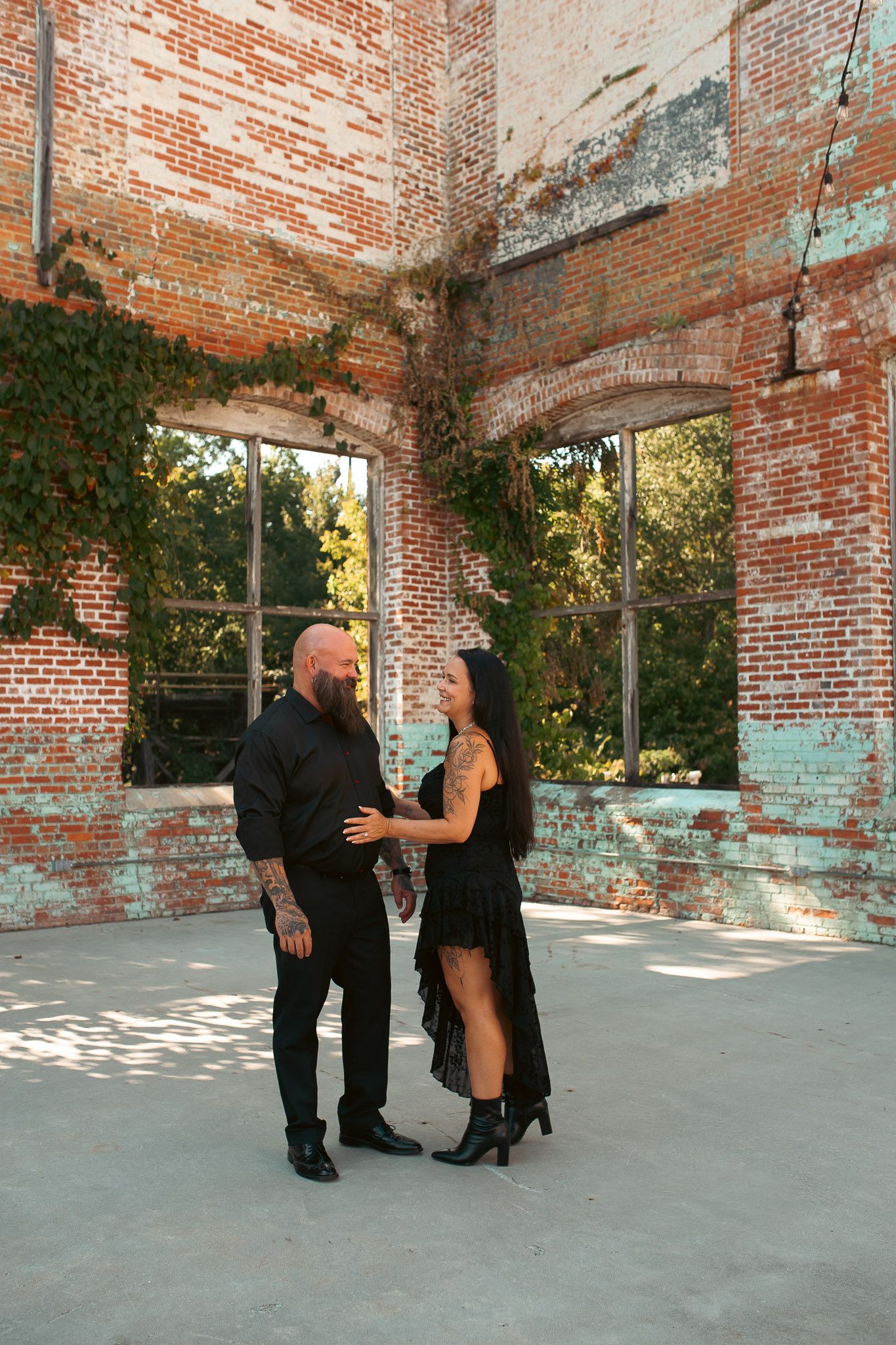 Couple in industrial ruins setting for engagement session in Lindale Mill.