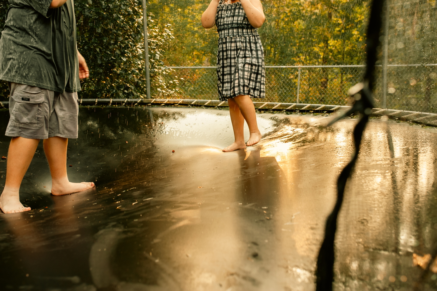 Detail image of son and daughter jumping on trampoline for lifestyle family session in Cartersville, GA.