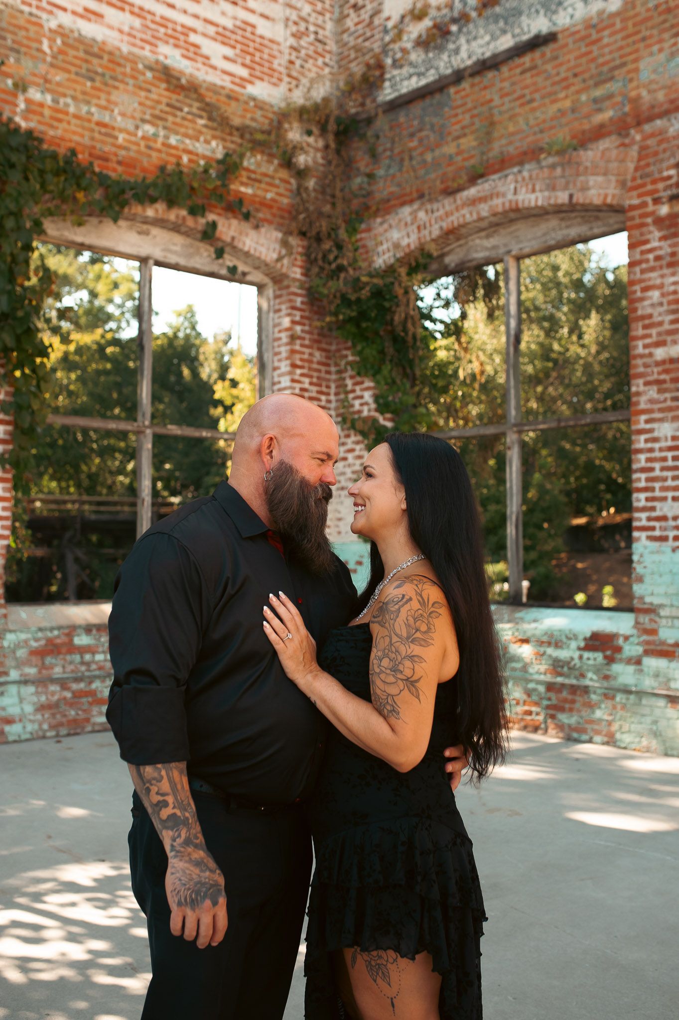 Sweet picture of couple in engagement picture in summer outside industrial ruins in Northwest GA.