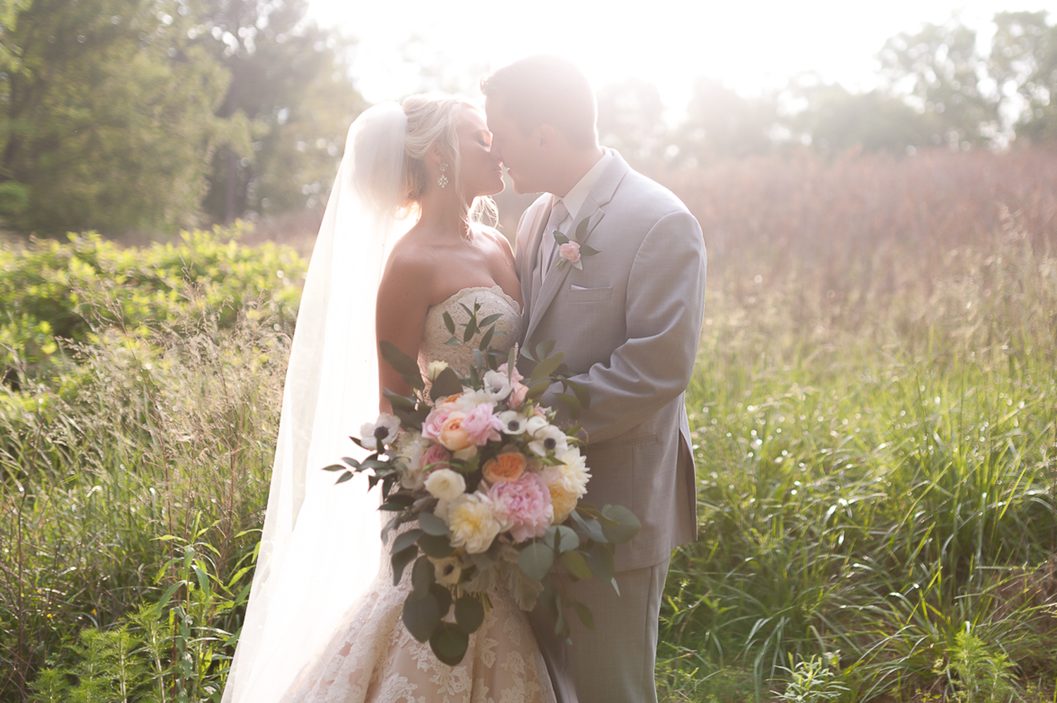 Bride and groom during formal portraits in golden field in North Georgia.