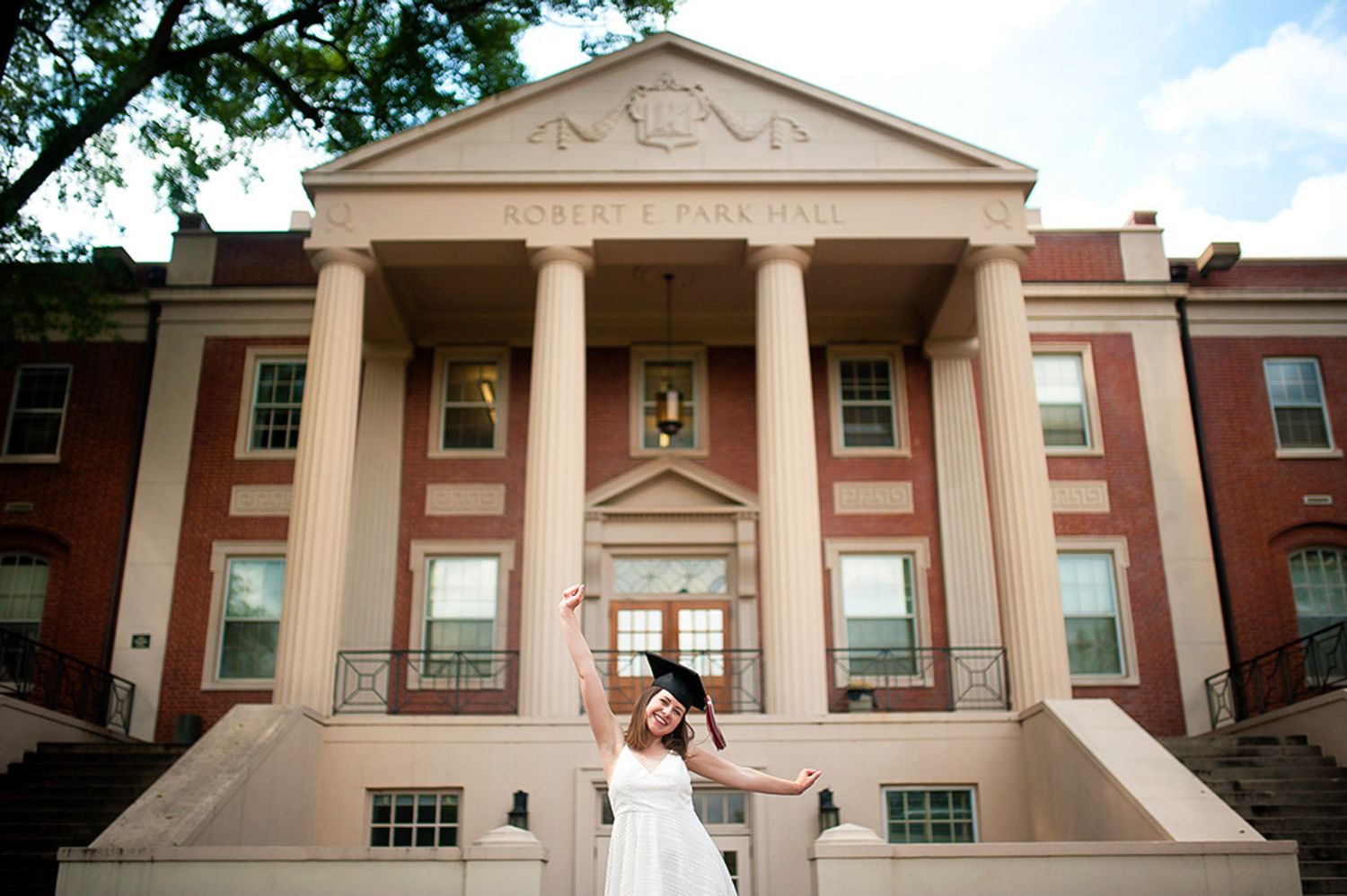Graduation photo of senior in front of Park Hall at UGA.