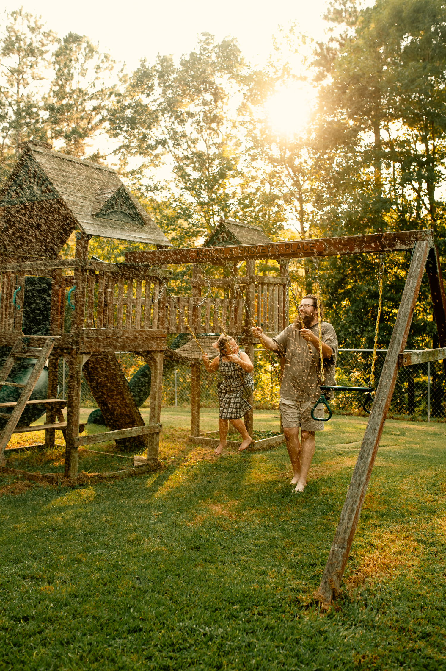 Dad and daughter swinging on swingset for family photos in Cartersville, GA.