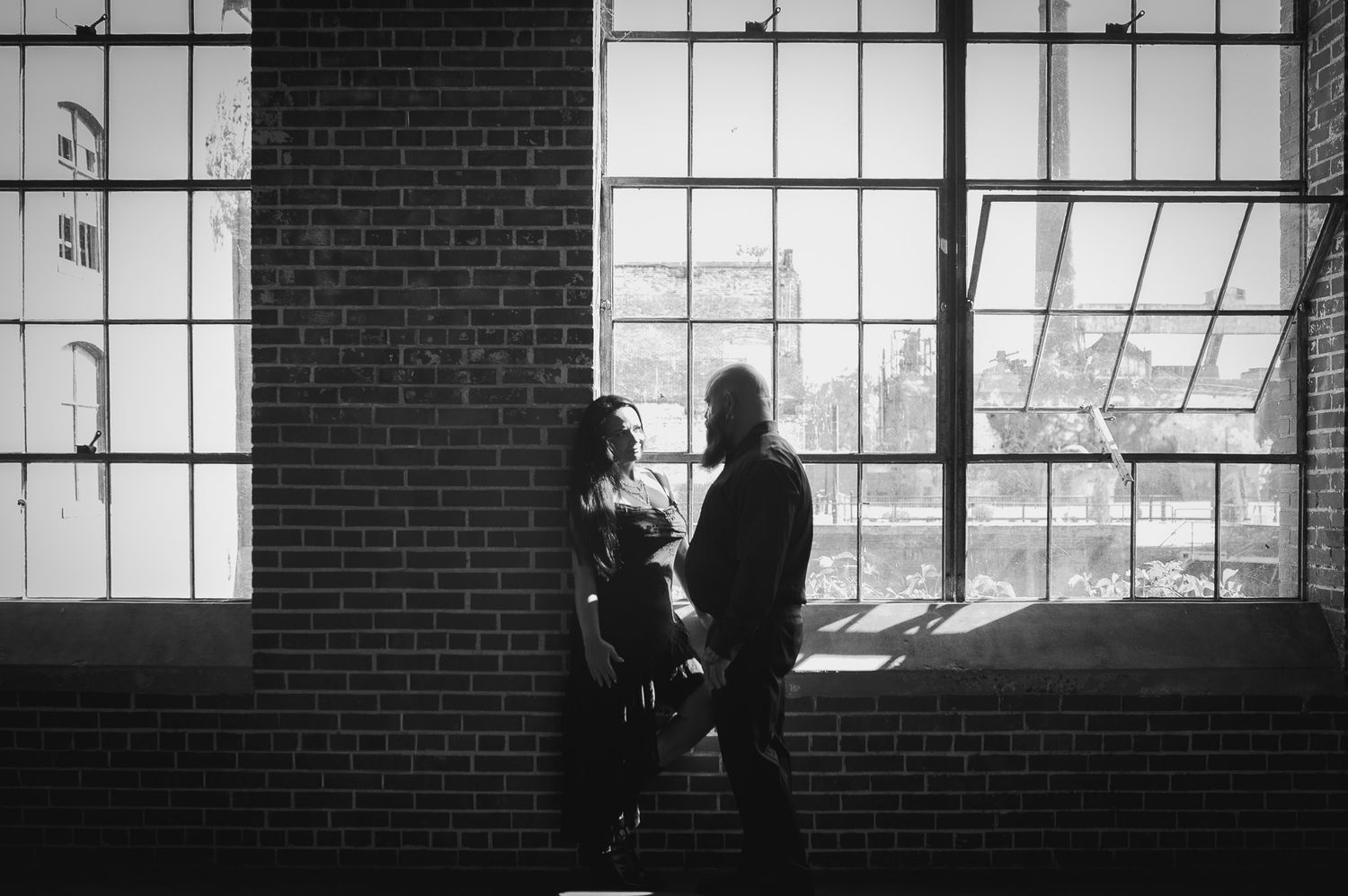 Black and white couple portrait in moody engagement session at Lindale Mill.