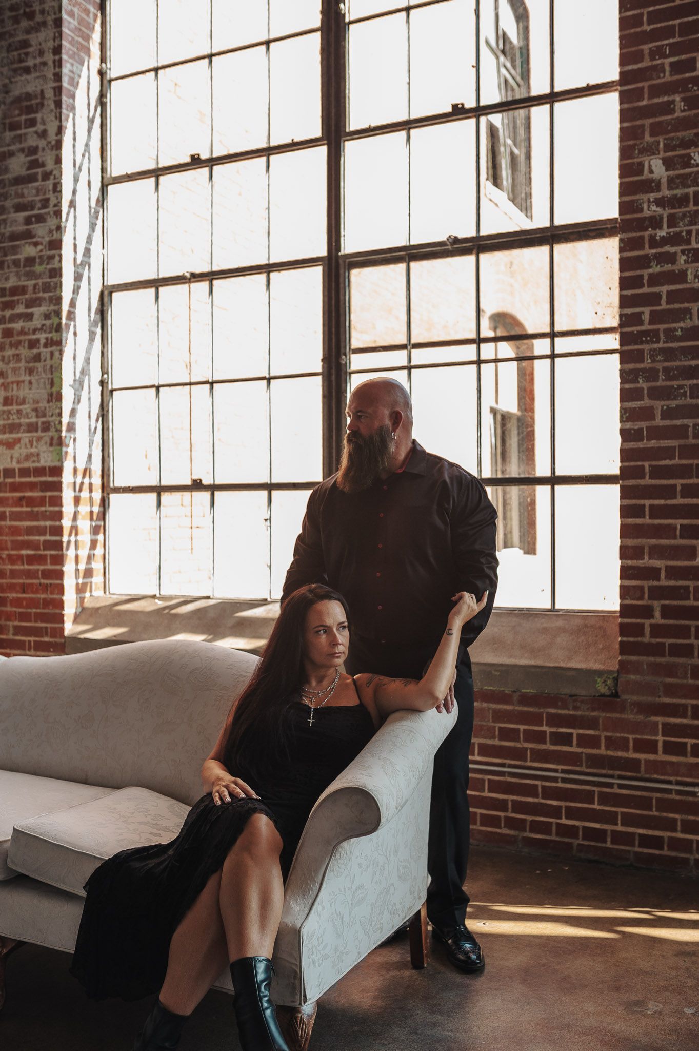 Couple posing on couch in NW GA Lindale Mill for engagement session before wedding.
