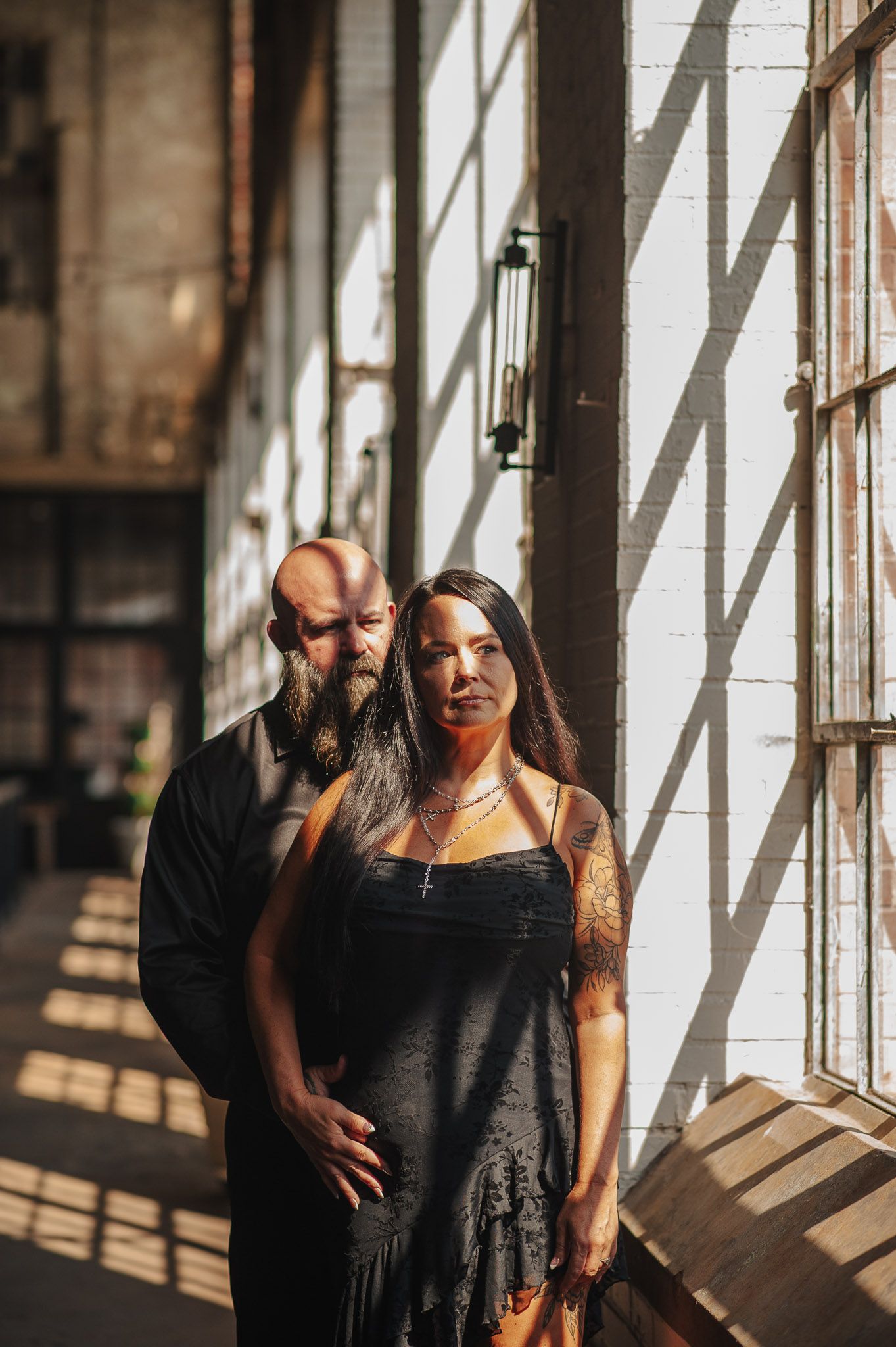 Couple in edgy lighting in industrial Lindale Mill in Rome Georgia for engagement session.
