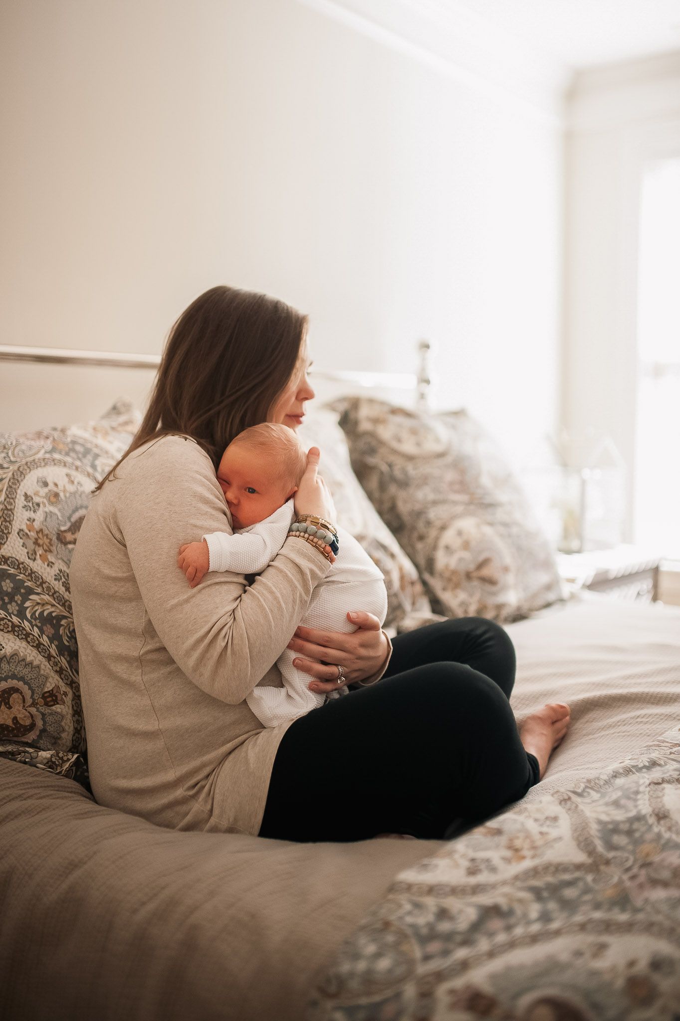 Mom holding baby in at home newborn session in Marietta, GA.