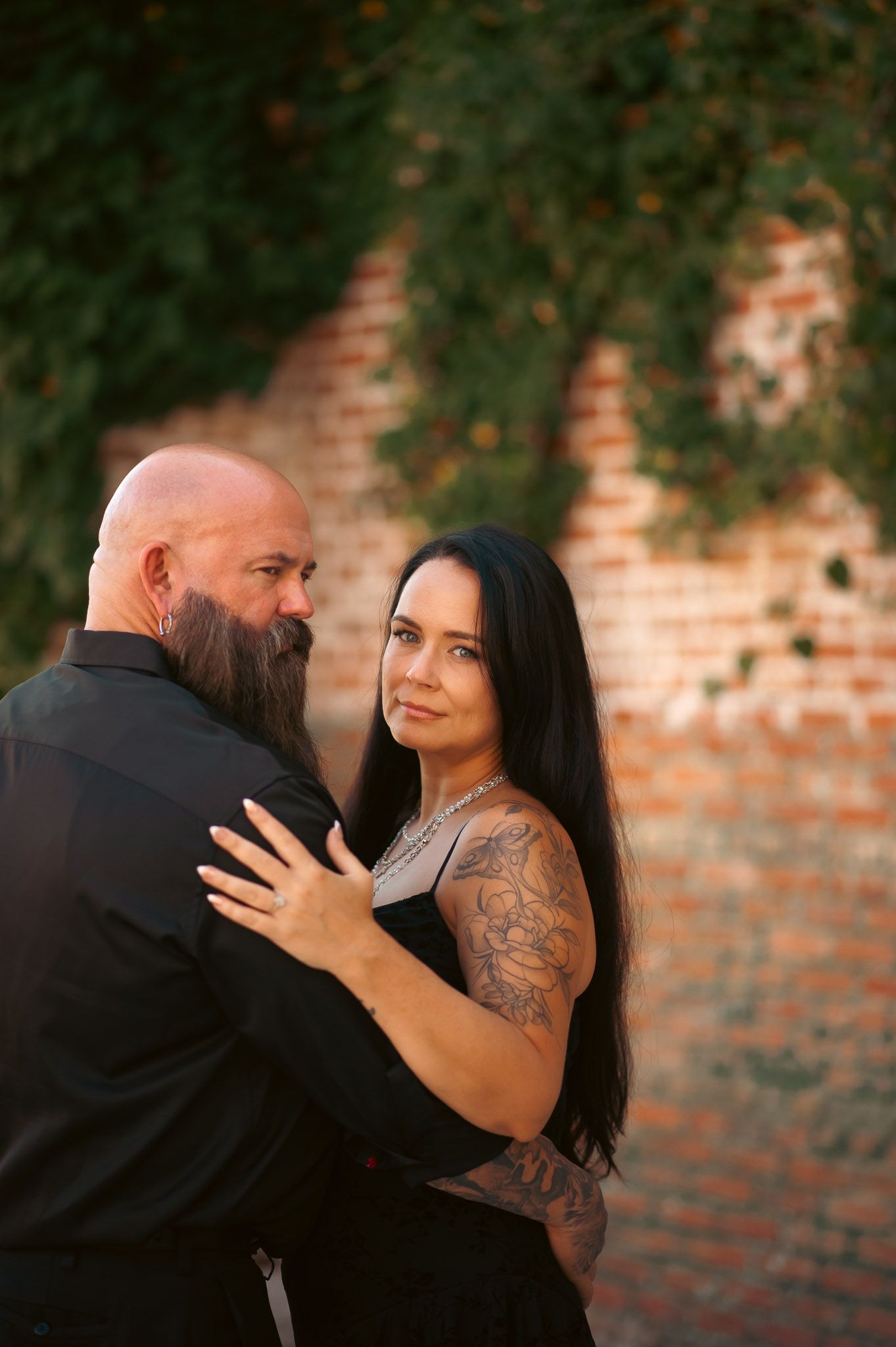 Tattood couple in moody engagement shoot in Lindale Mill.