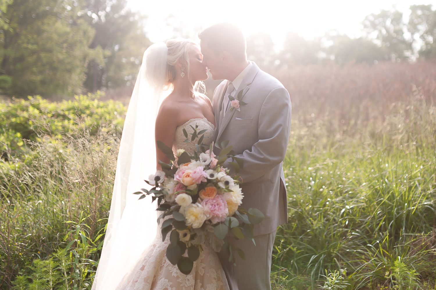 Bride and groom during formal portraits in golden field in North Georgia.
