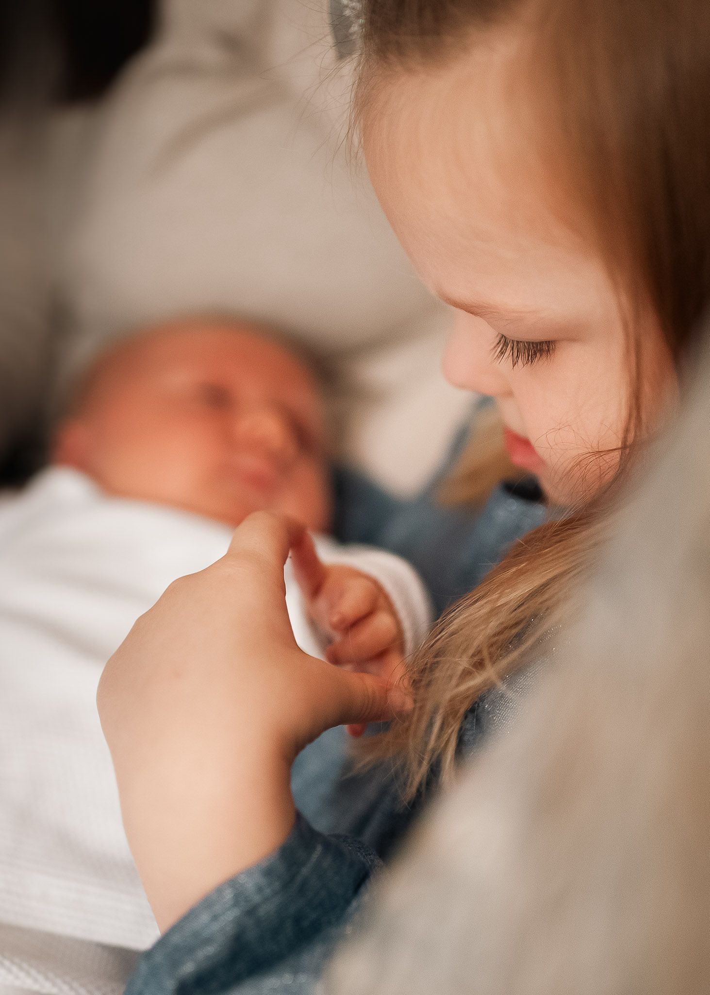Big sister admiring baby in at home newborn session in Northwest GA.