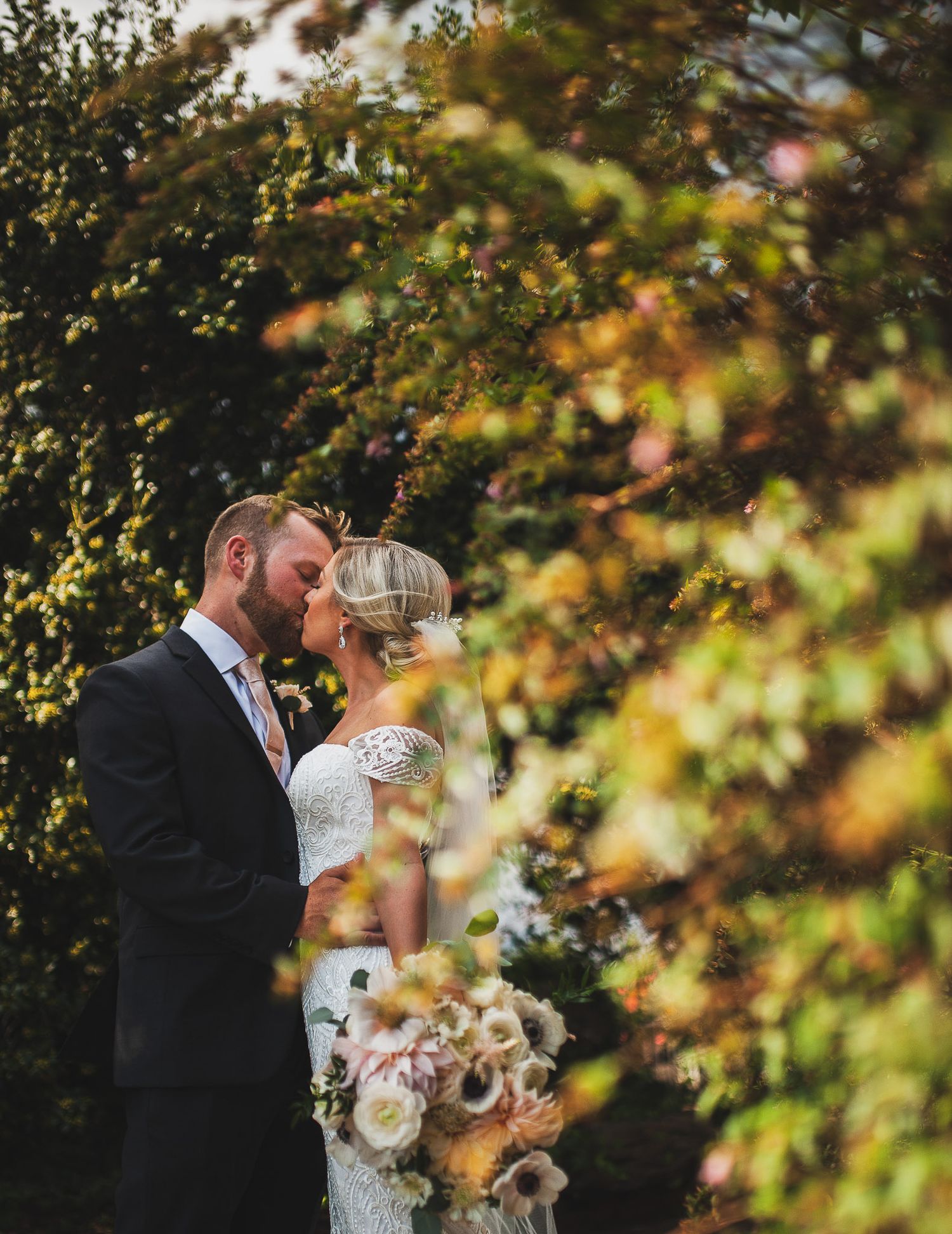 Bride and groom kissing during formal photos at Frogtown Vineyard in Georgia.