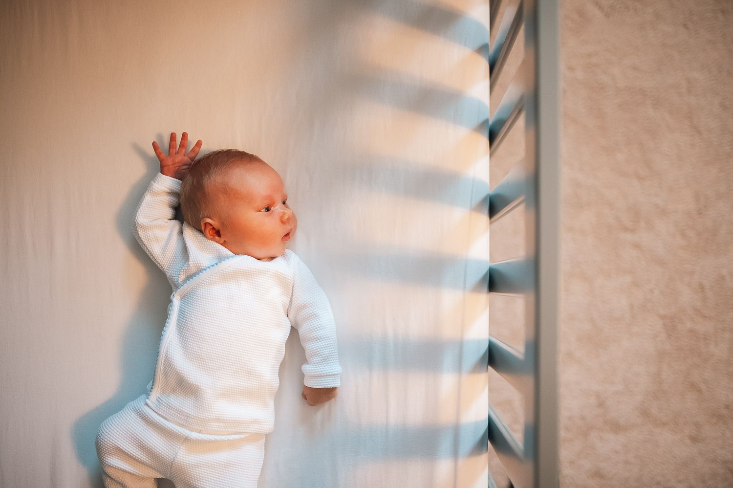 Baby in crib during Marietta at home newborn session.