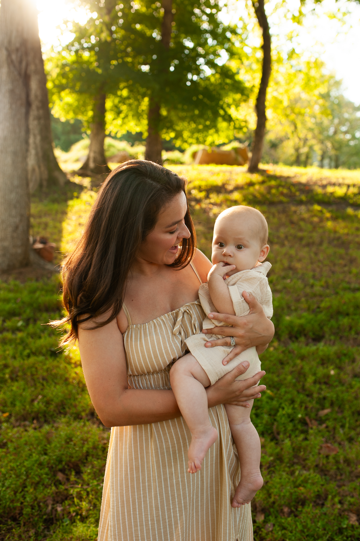 Mom admiring her baby with warm golden glow in fall family photos in Cartersville, GA.
