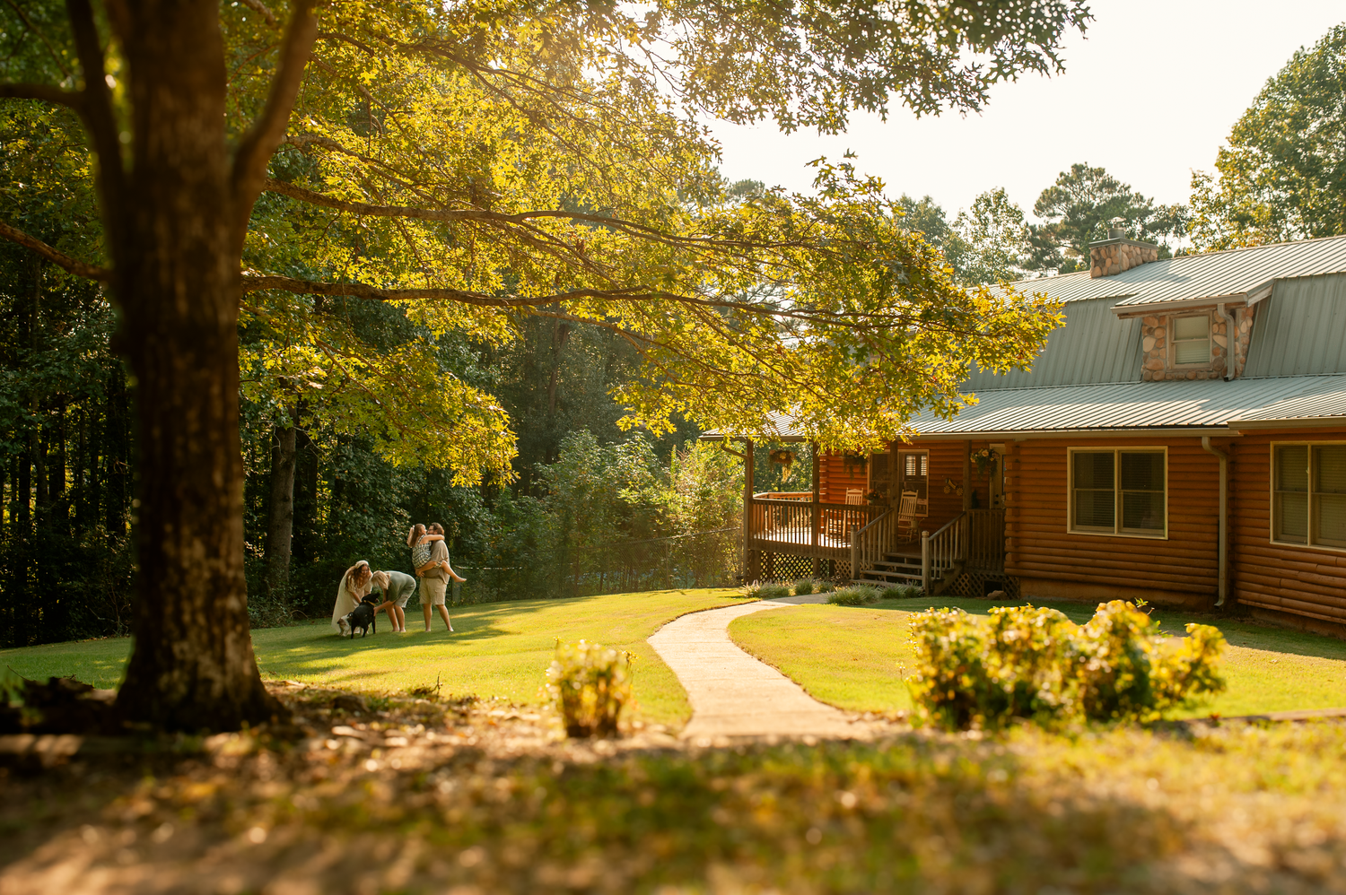 Family playing in the yard with their dogs for lifestyle family photos in Cartersville, GA.