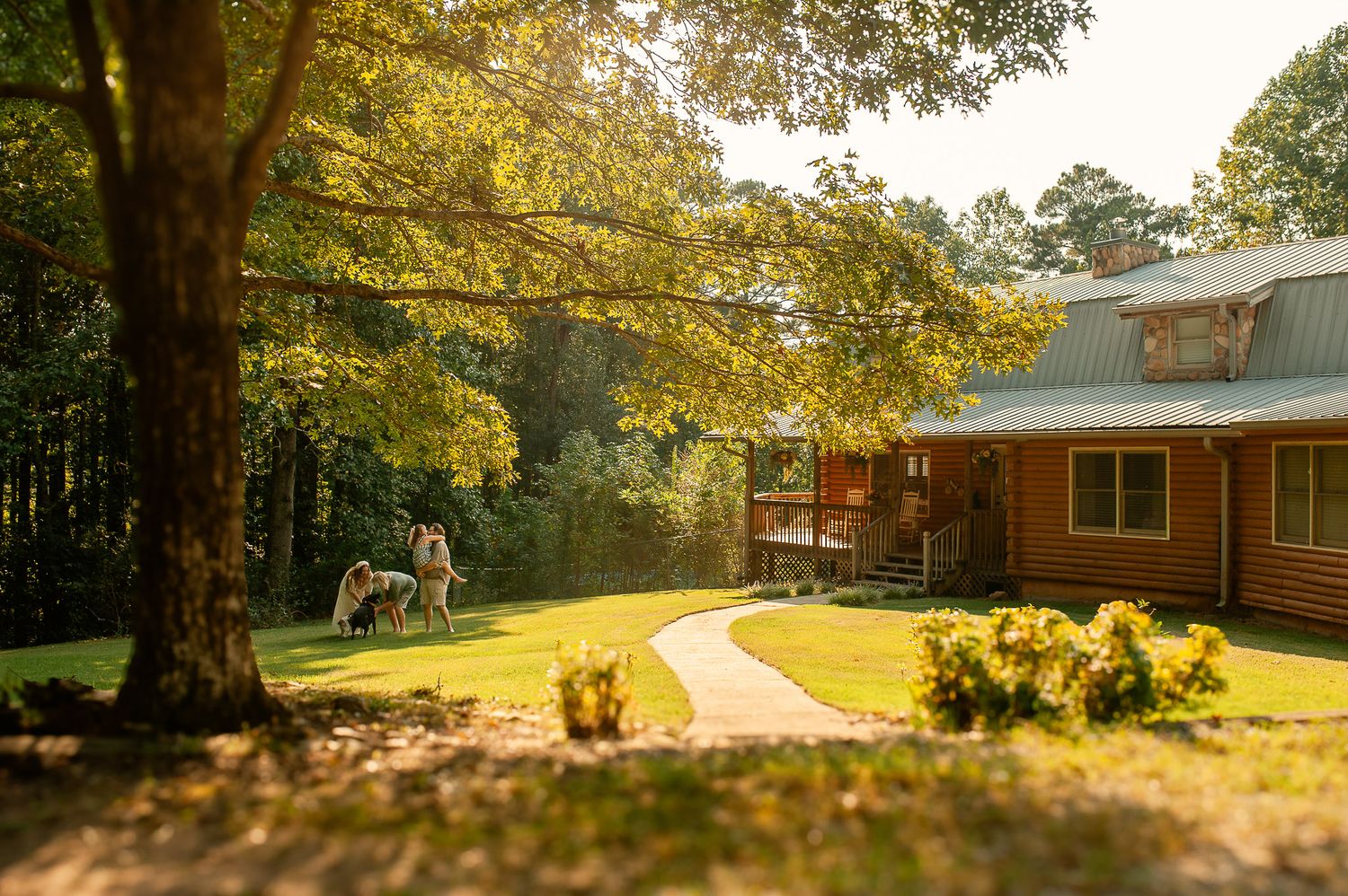 Family playing in the yard with their dogs for lifestyle family photos in Cartersville, GA.