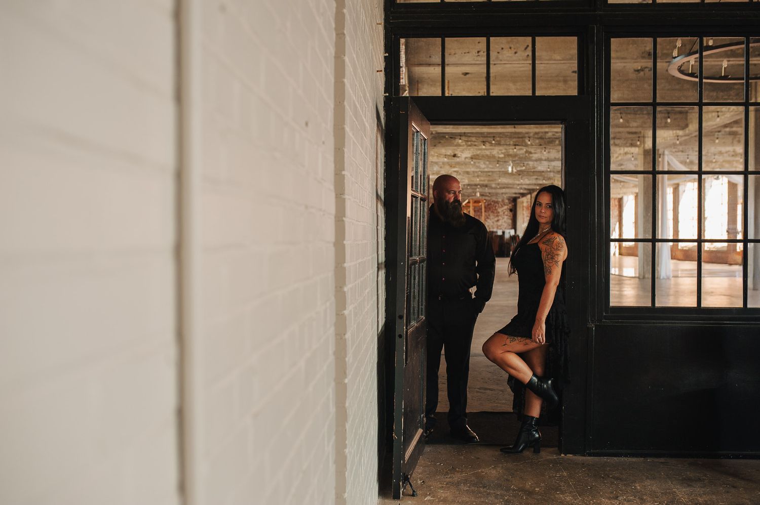 Couple standing in doorway for engagement session in Lindale Mill, GA.