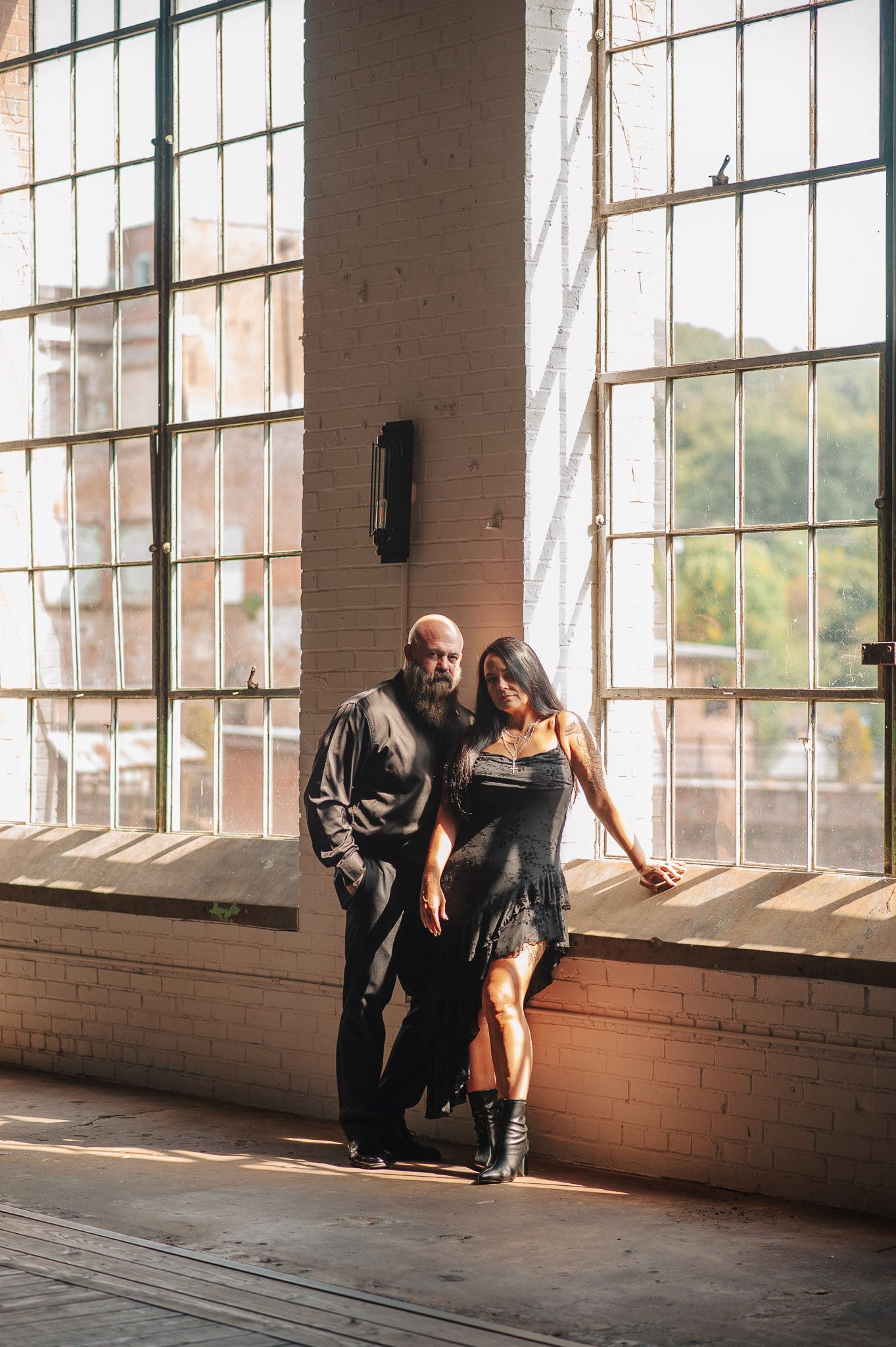Posed editorial shot of couple for engagement session before wedding in industrial Lindale Mill in Northwest Georgia.