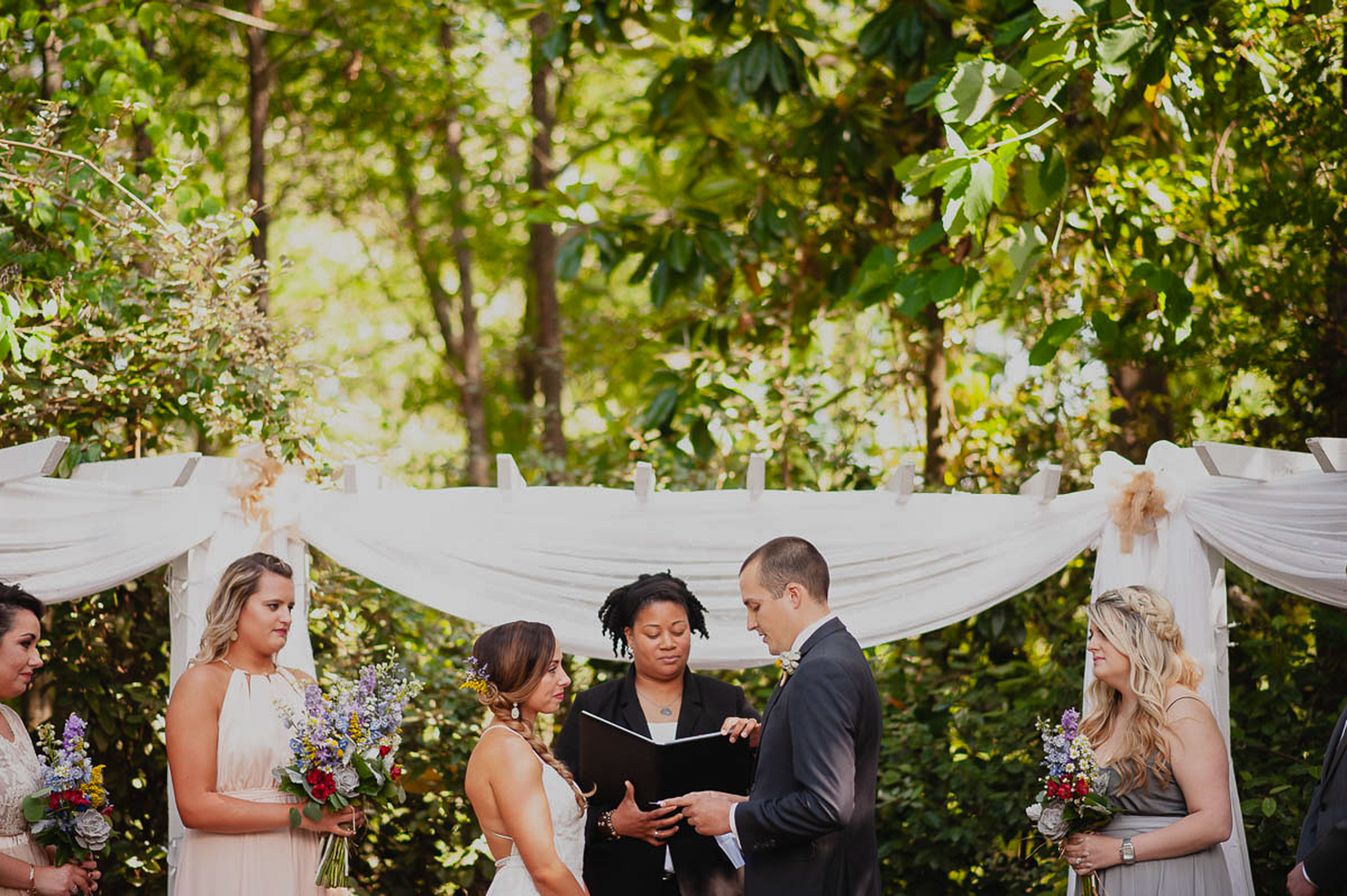 Ceremony photograph of bride and groom in colorful wedding in Atlanta.