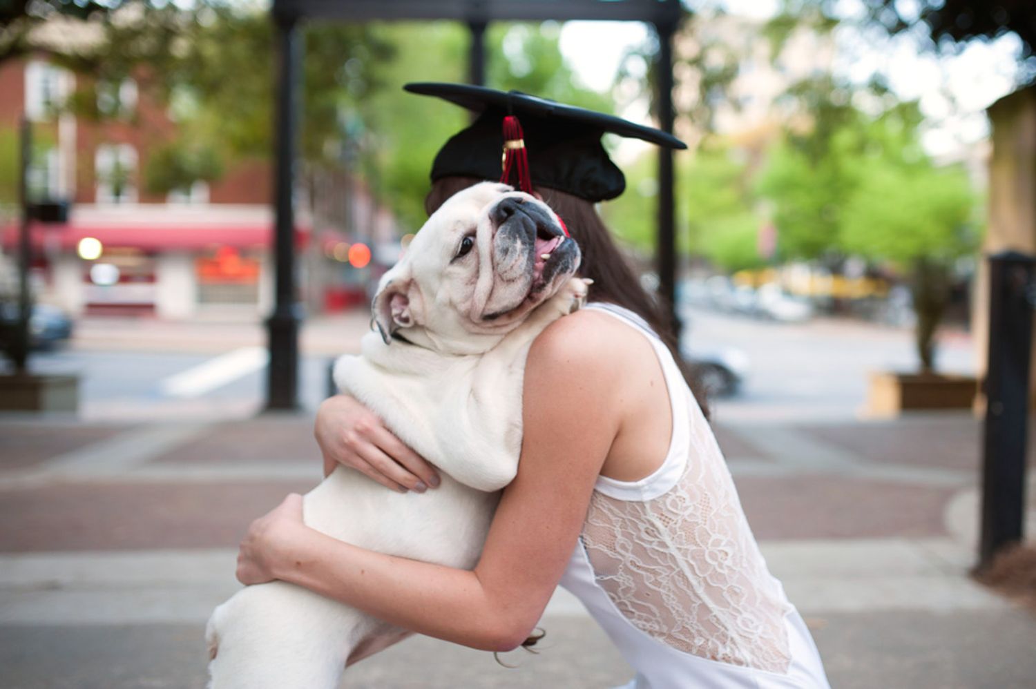Graduation photo of girl at UGA with her bulldog.