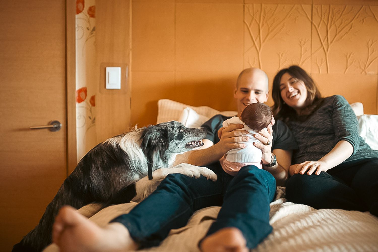 Family admiring baby with dog in Acworth Georgia home newborn session.