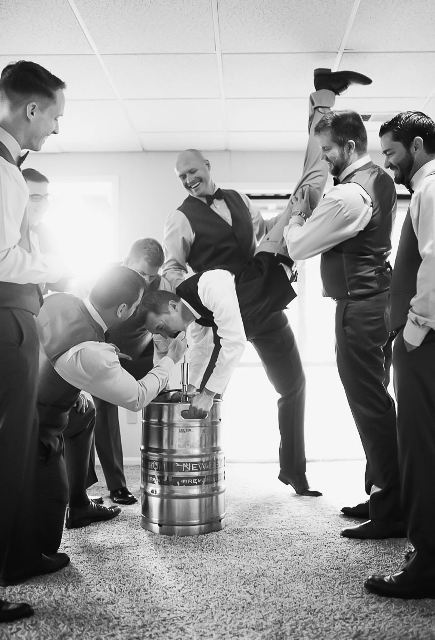 Groomsmen doing a keg stand before ceremony in Birmingham wedding.