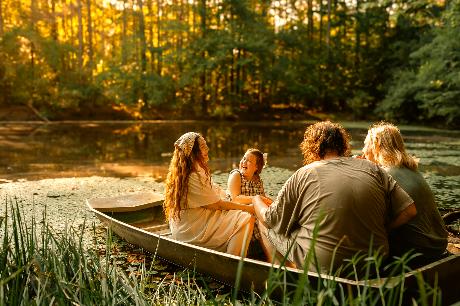 Family in boat in lake for family photos in Cartersville, GA.