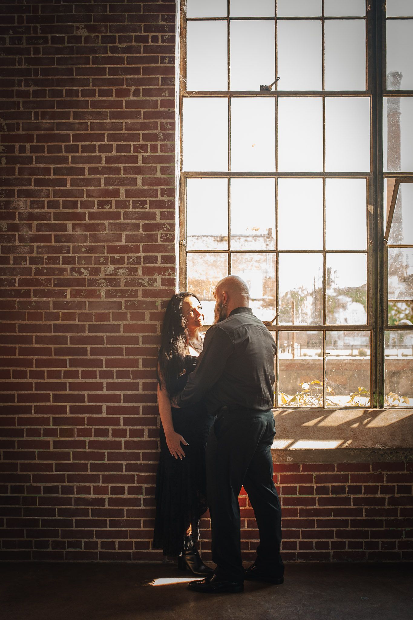 Vertical shot of couple in engagement session in dye room in Rome, GA.