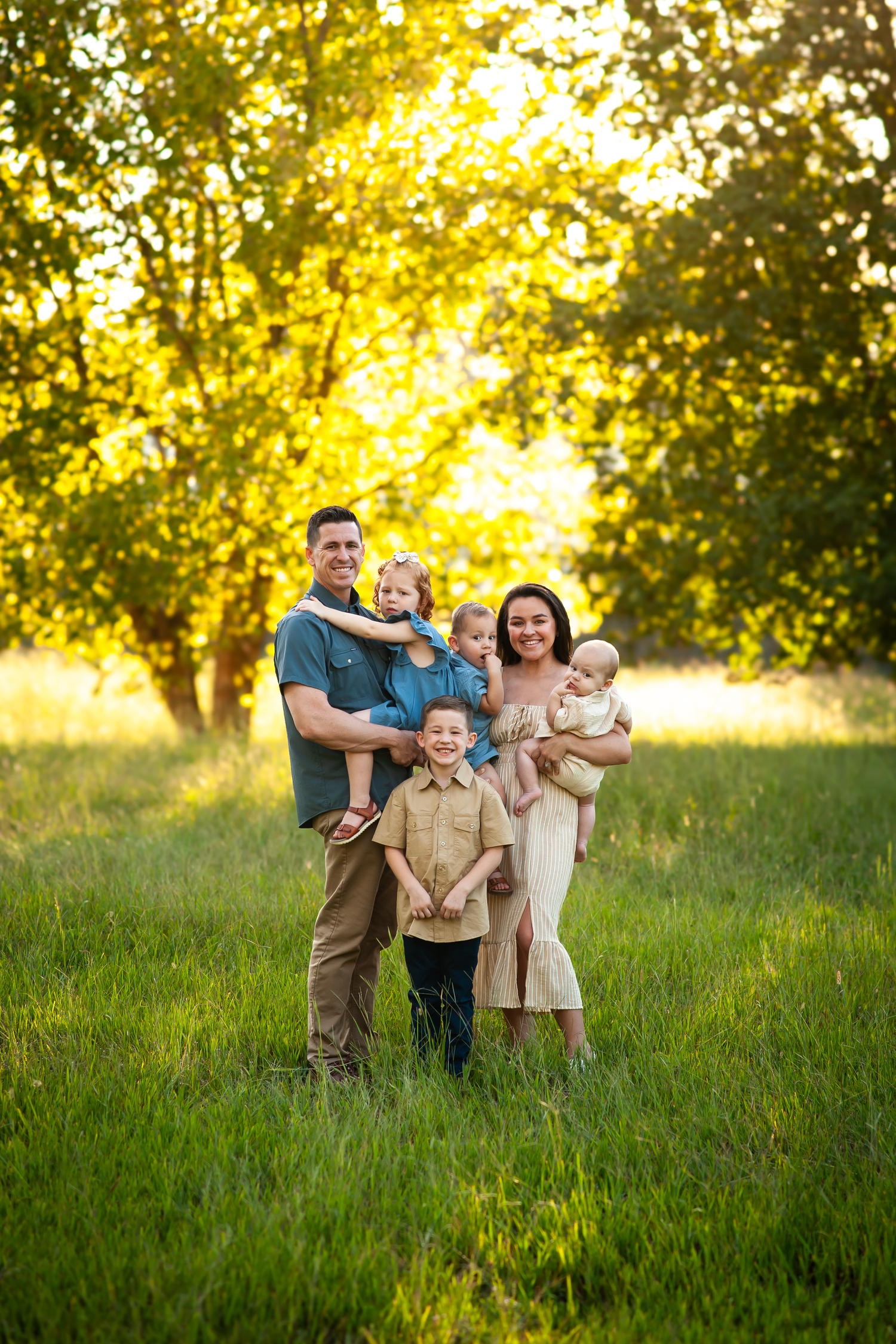 Fall family portrait with four children in field with golden glow in Cartersville, GA.
