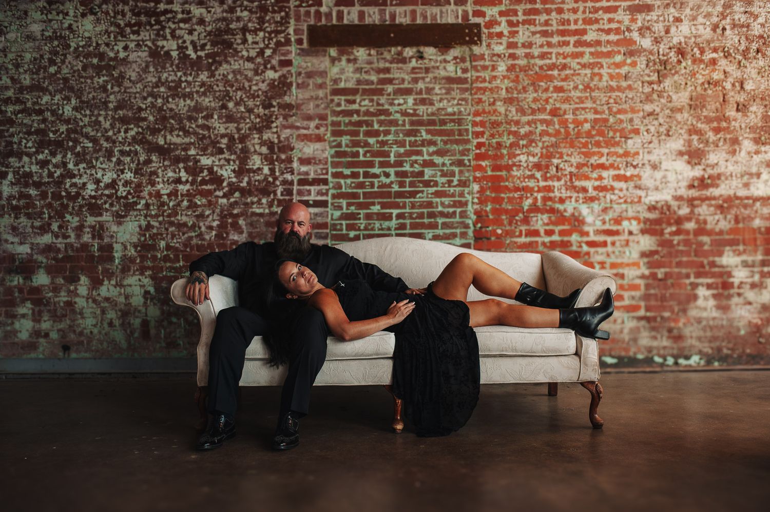 Couple posing on couch for engagement session in Lindale Mill GA.