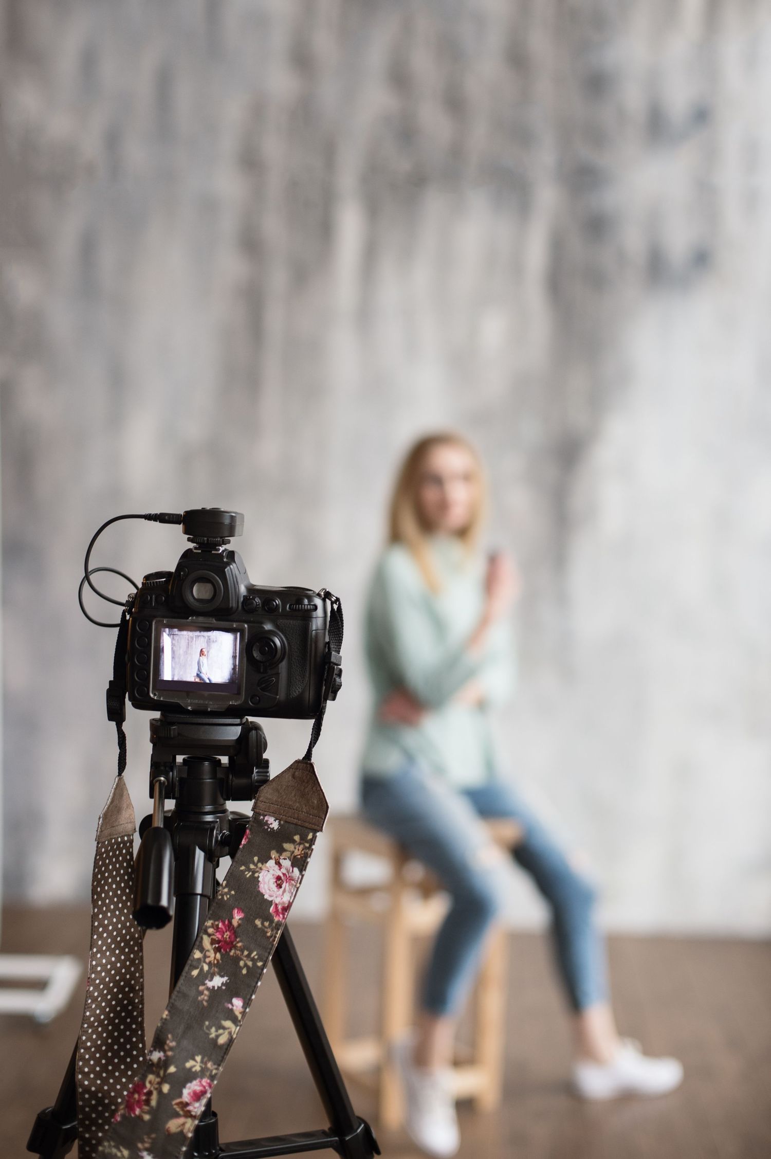 Professional camera setup with focus on camera body and lens against a blurred background.