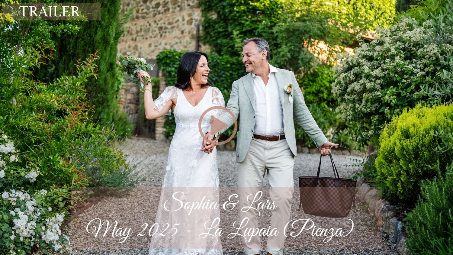 A couple walks together through a lush garden path during their wedding photoshoot.