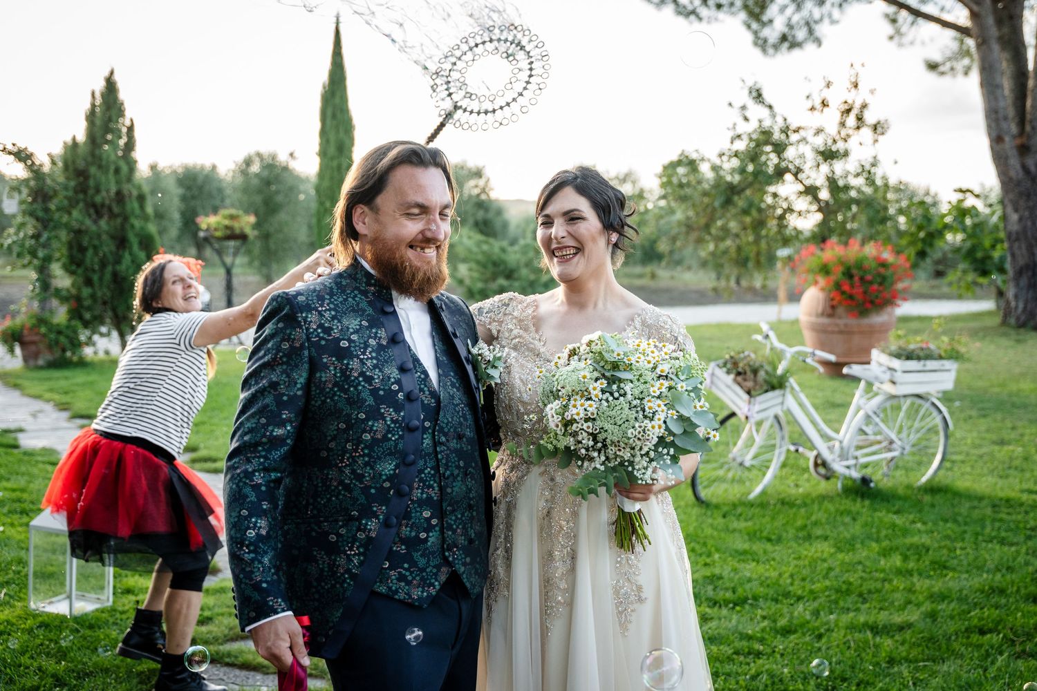Couple shares an intimate moment in a lush garden setting during their wedding celebration.