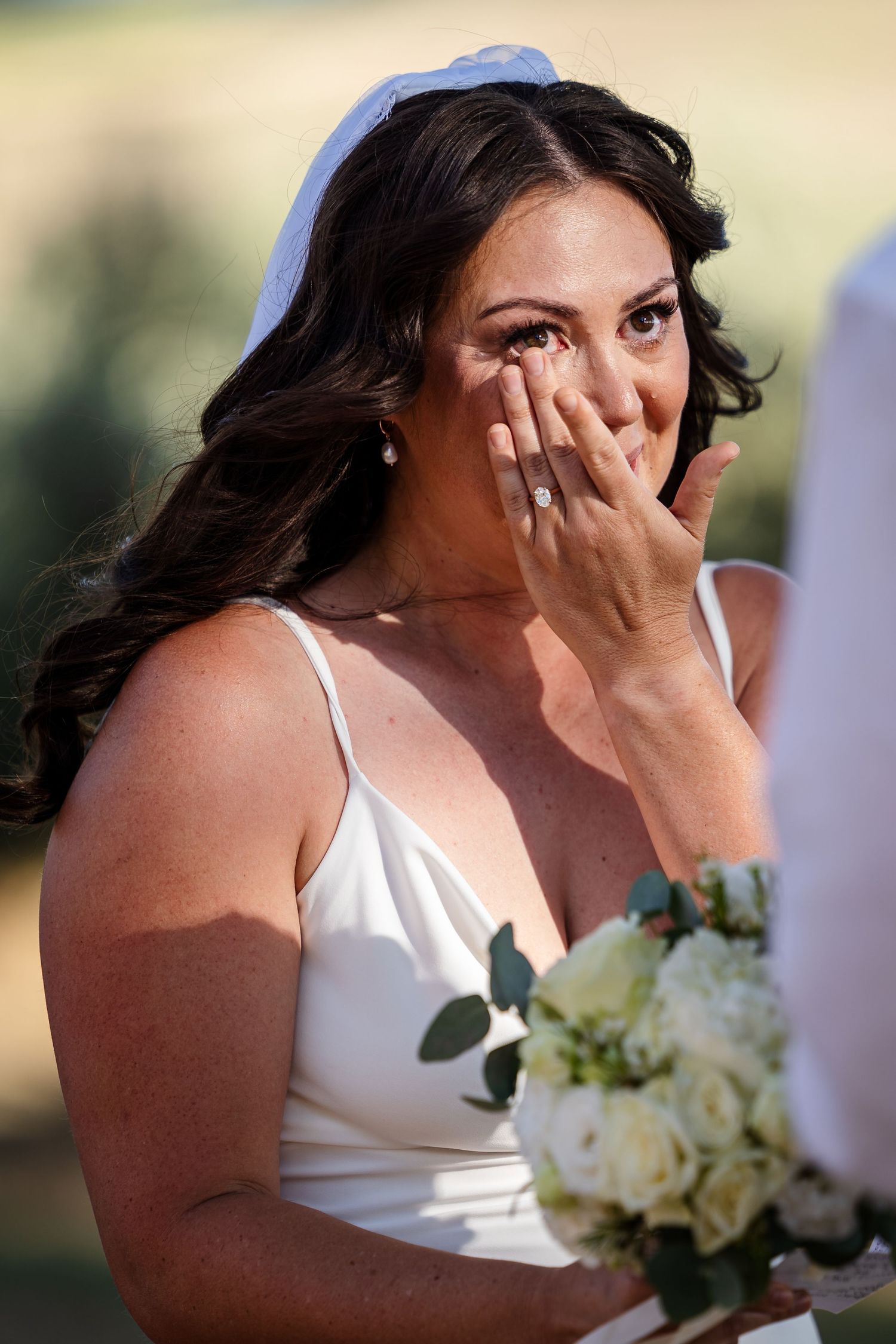A series of emotional bridal portraits showing joyful tears and laughter while holding a white bouquet.