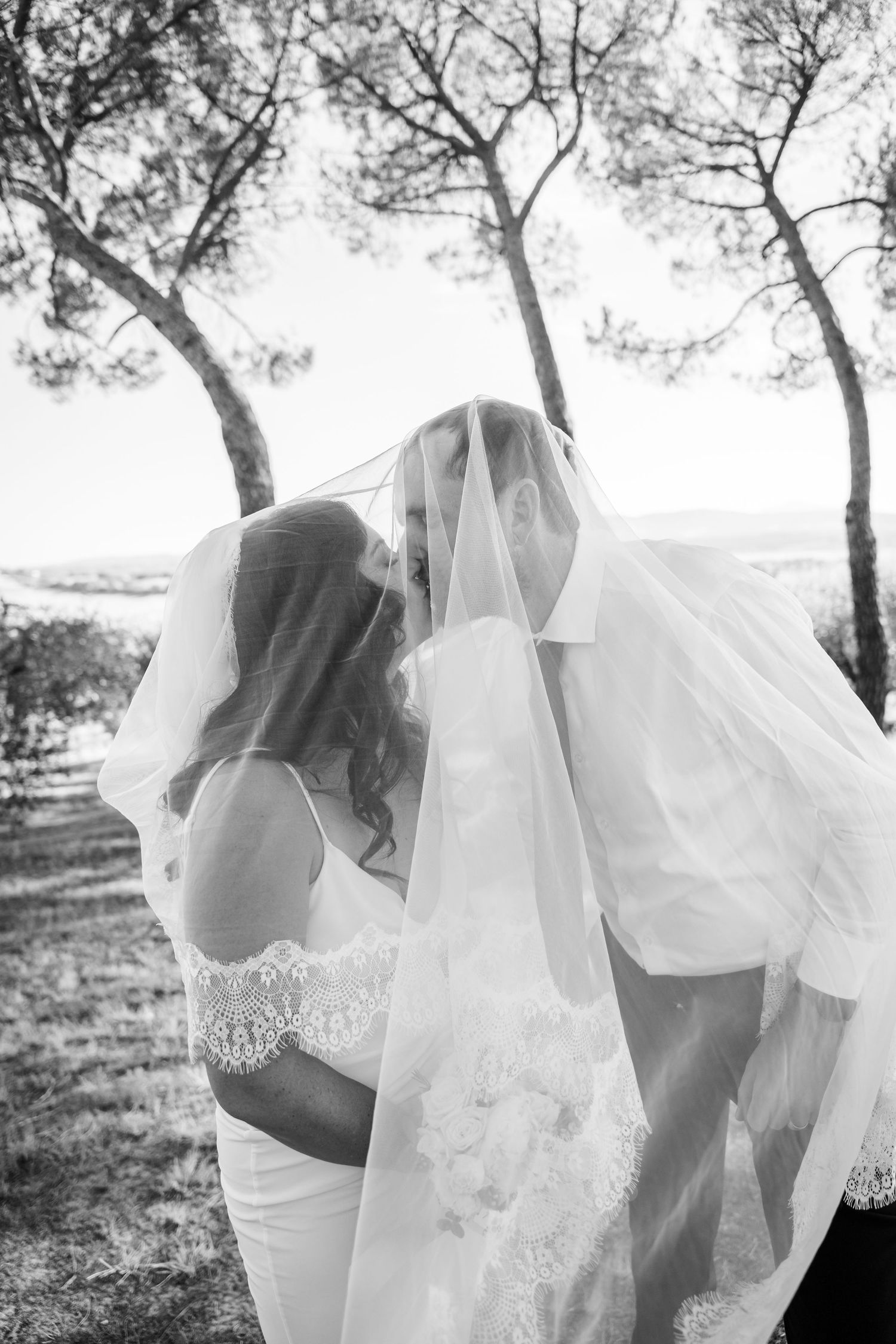 Black and white wedding portraits showing ethereal moments with flowing veil and romantic poses.
